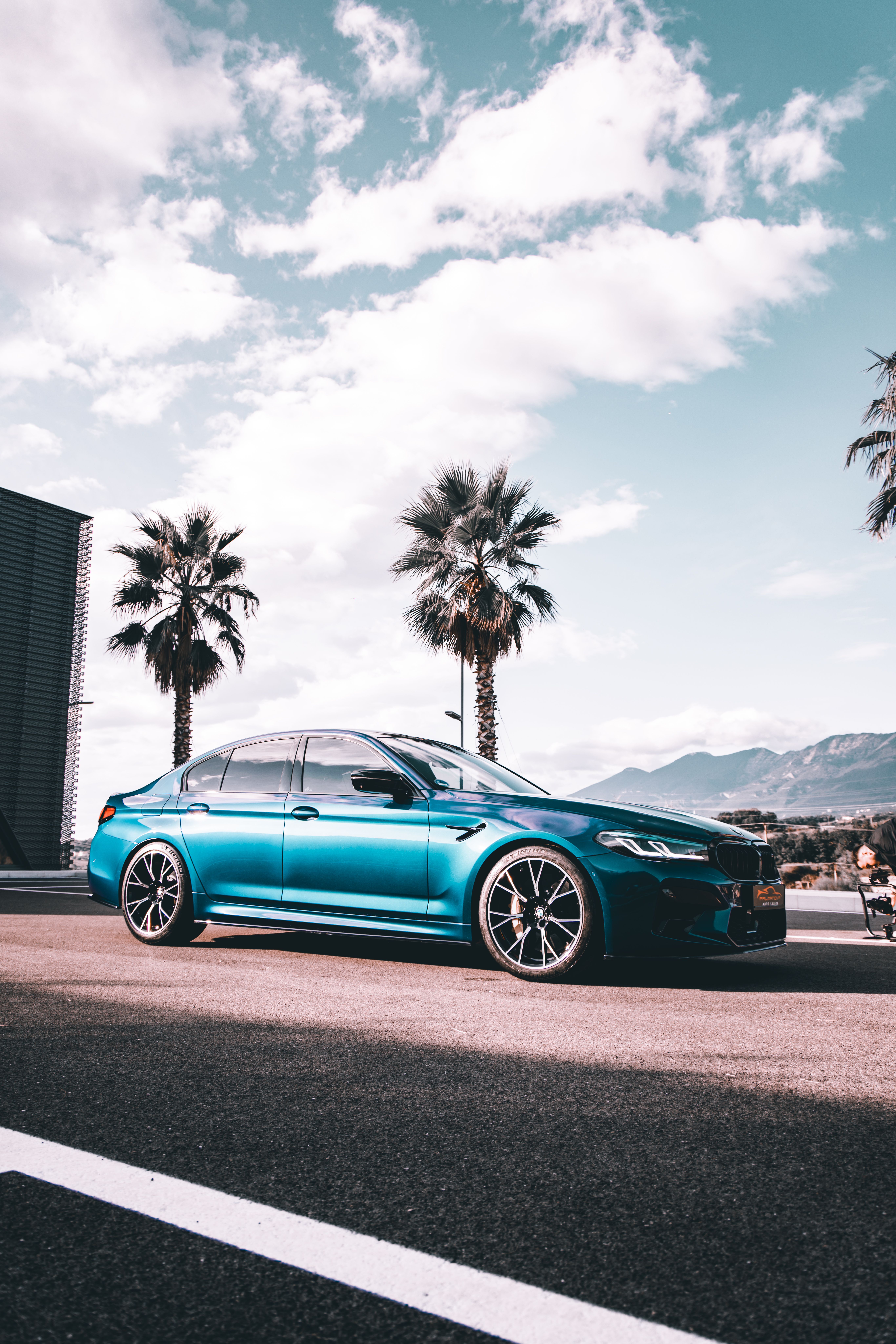 5464x8192 A Blue BMW M5 Parked on a Street at Night · Free