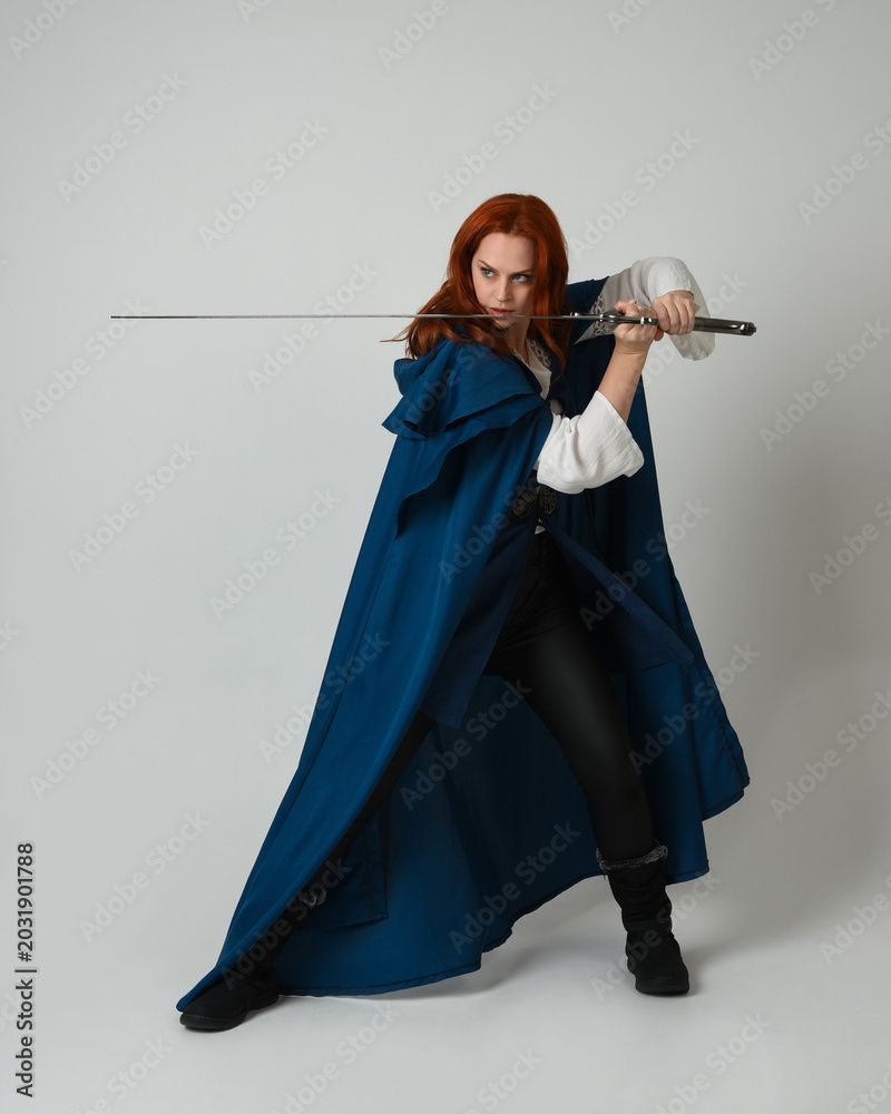 800x1000 full length portrait of female model wearing medieval fantasy warrior historical costume with blue cloak Wall Mural