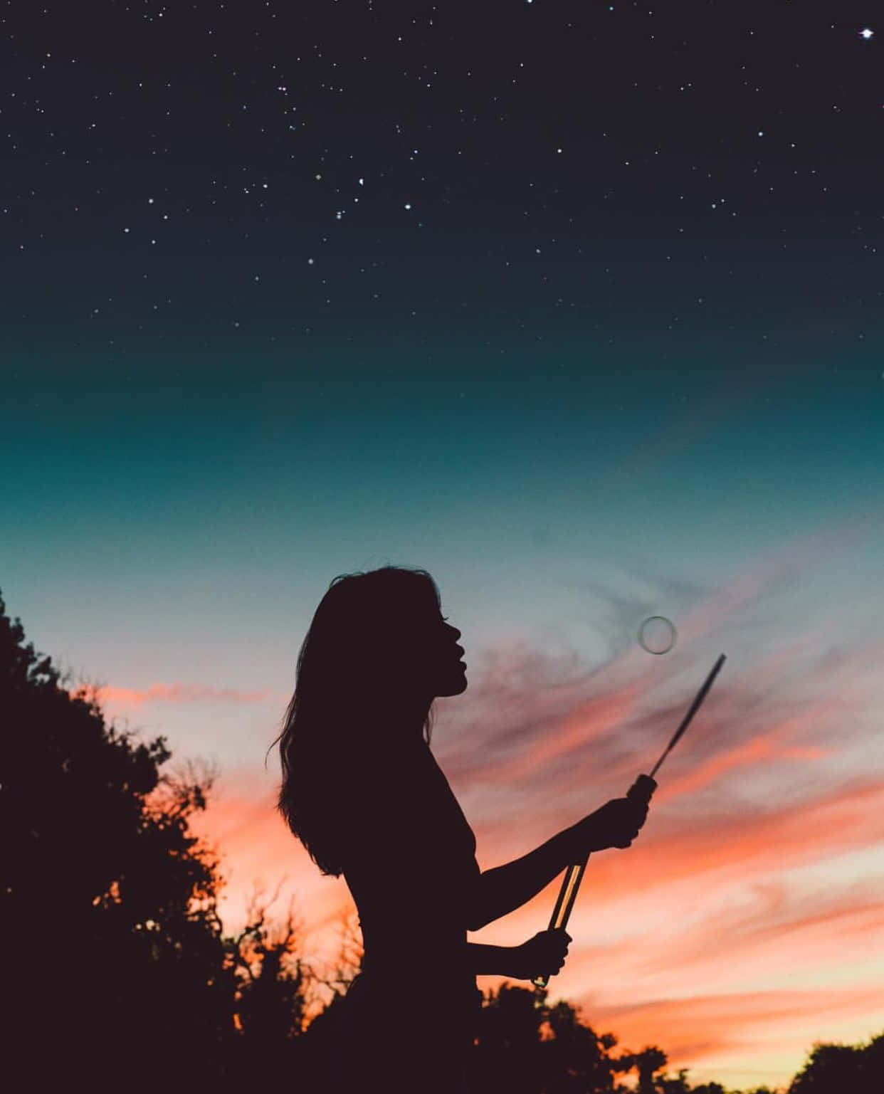 1242x1537 Download A girl stands in the shadows, enshrouded by the night. Picture