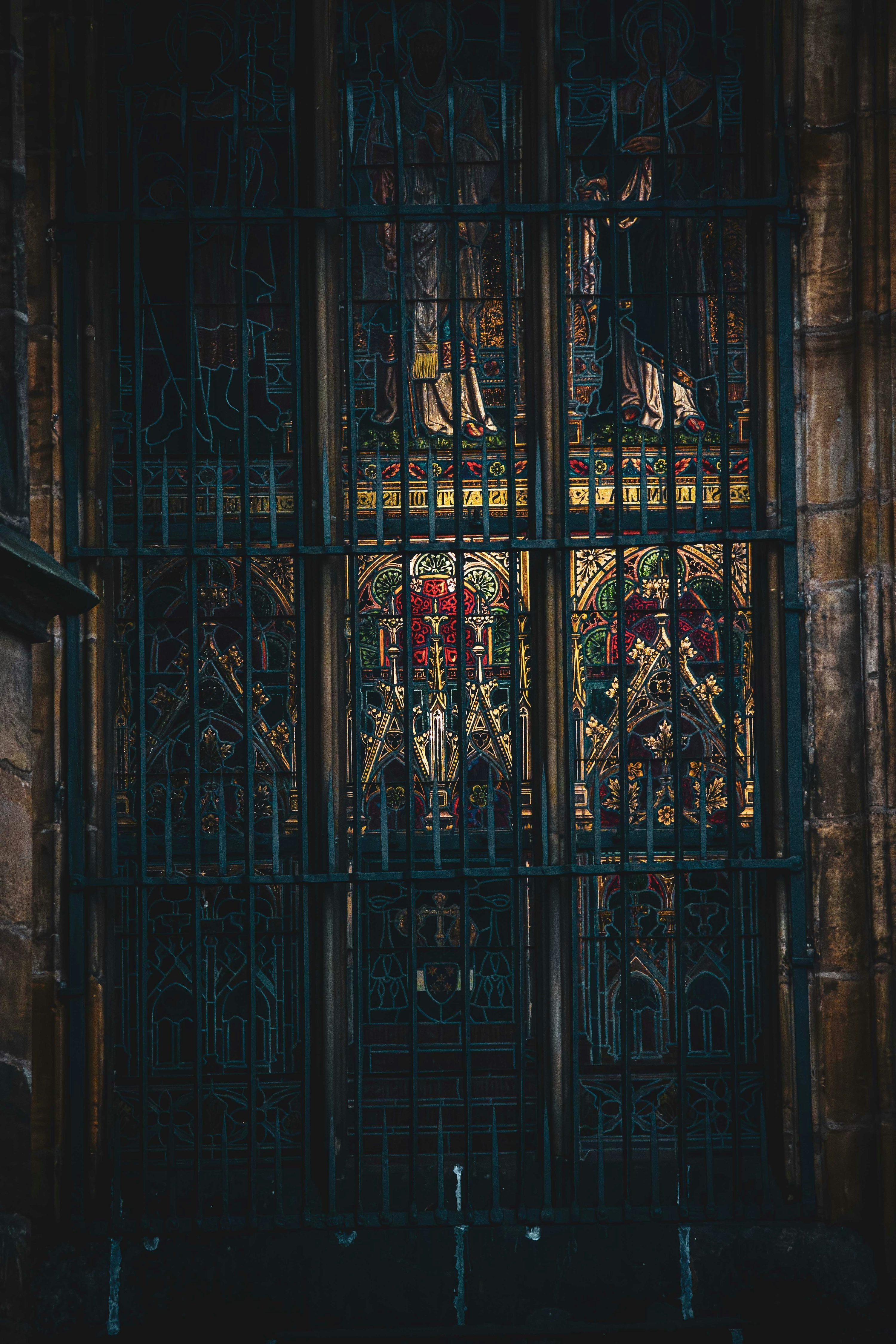 3000x4500 Ornate stained glass window behind metal bars