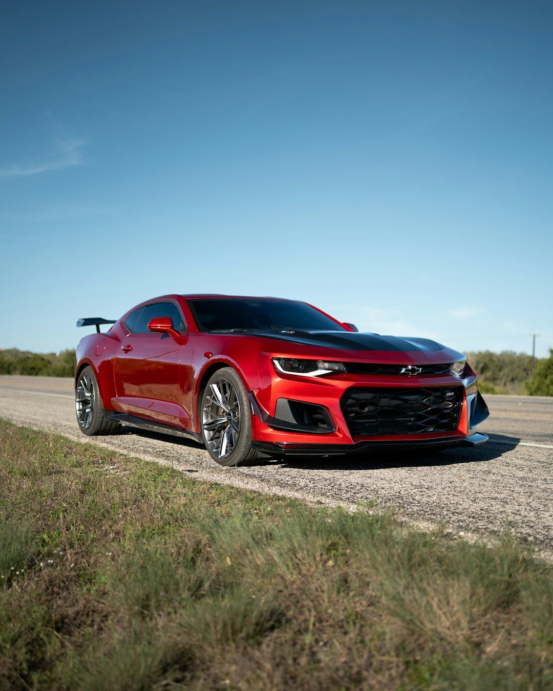 1080x1350 Red chevrolet camaro zl1 with spoiler on a rural road