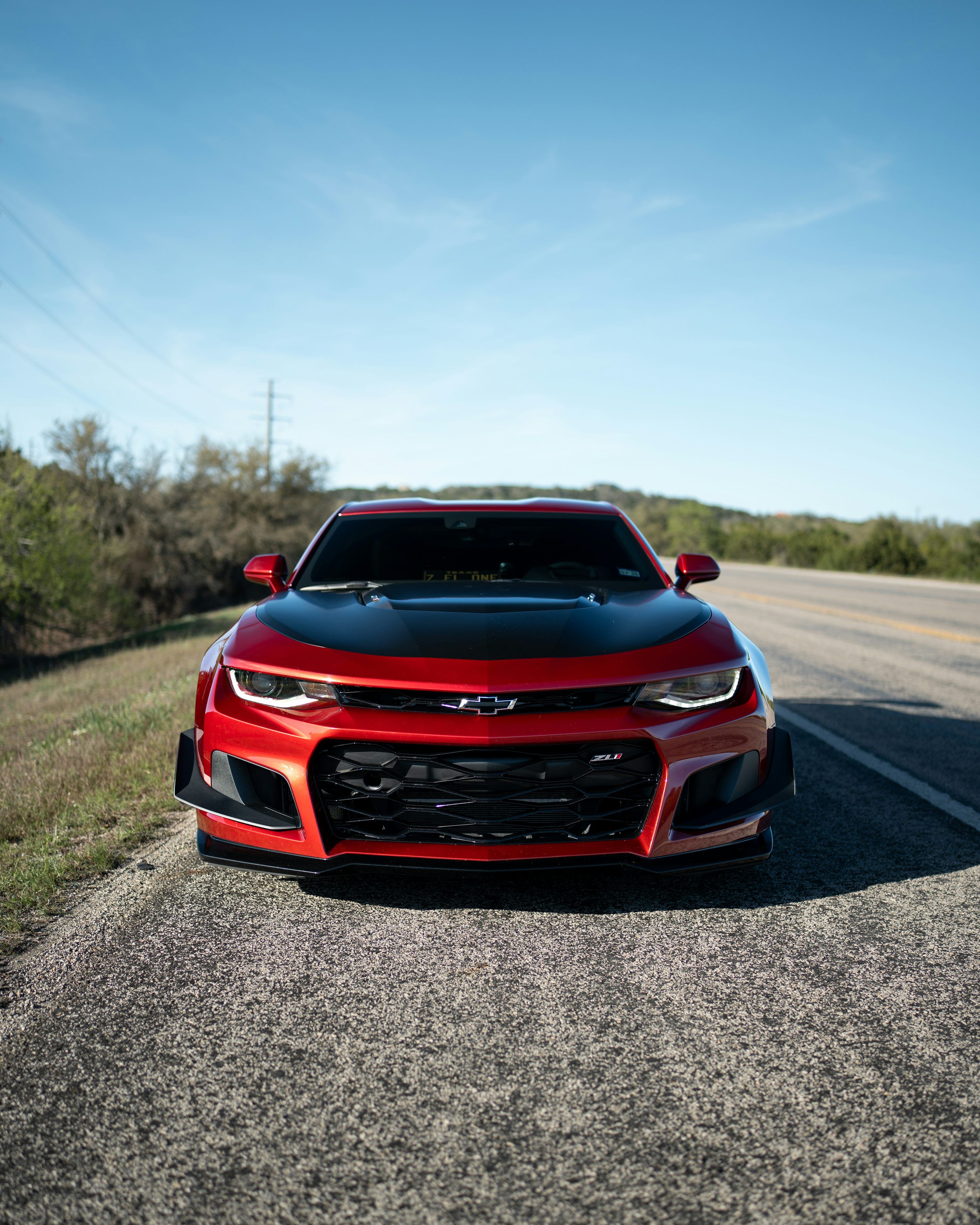 3000x3750 A red and black chevrolet camaro parked on a road