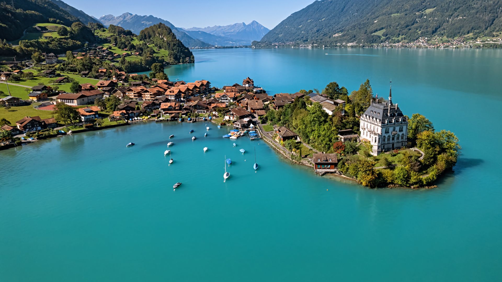 1920x1080 Aerial view of pictureque fishing village Iseltwald on Lake Brienz, Switzerland. Windows Spotlight Image