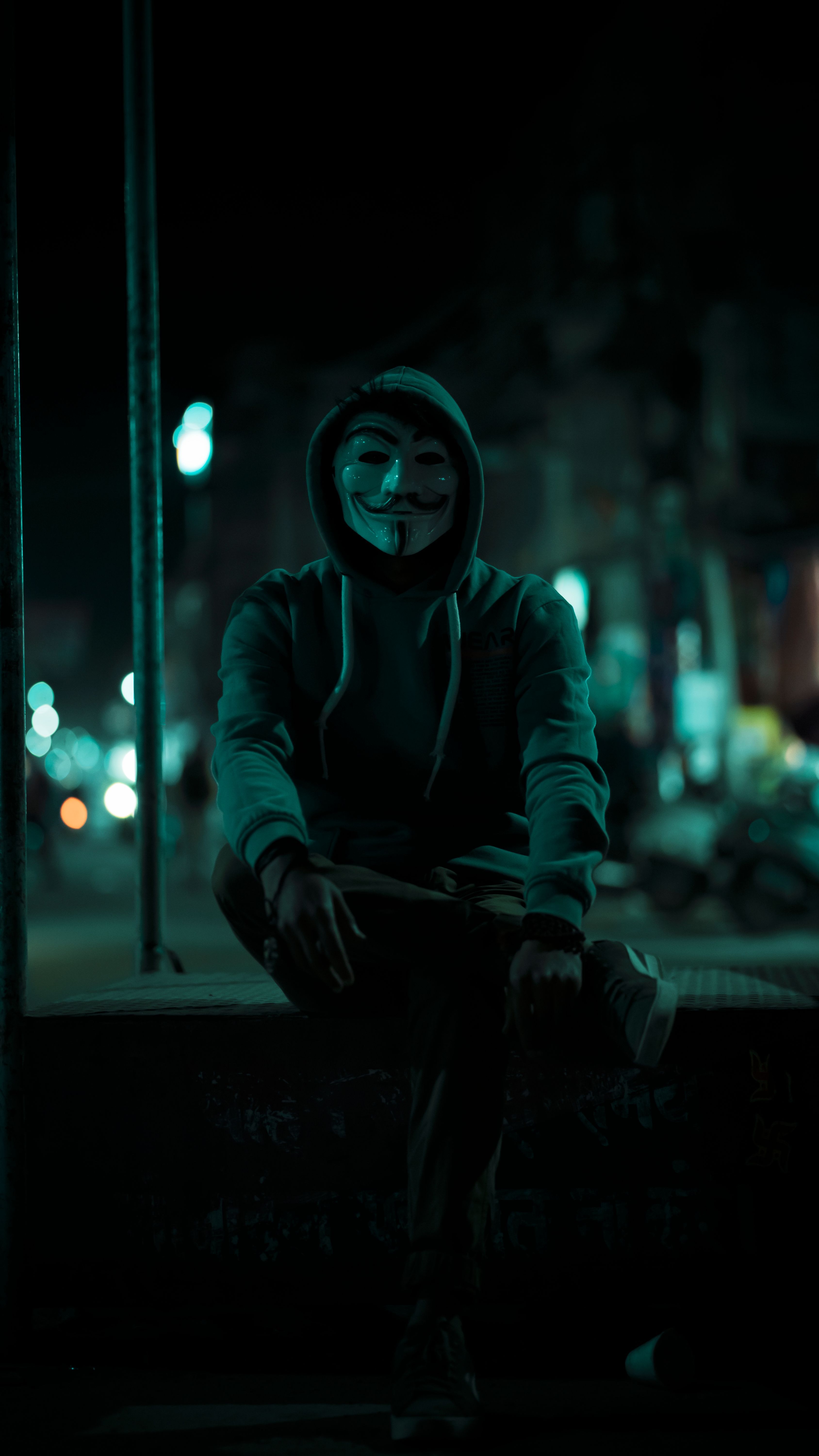 3376x6000 Anonymous Sitting on Wall at Night · Free