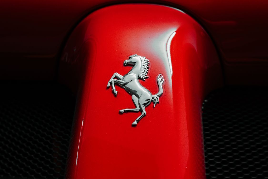 1125x750 Close Up Of Iconic Prancing Horse Logo On Red Car · Free