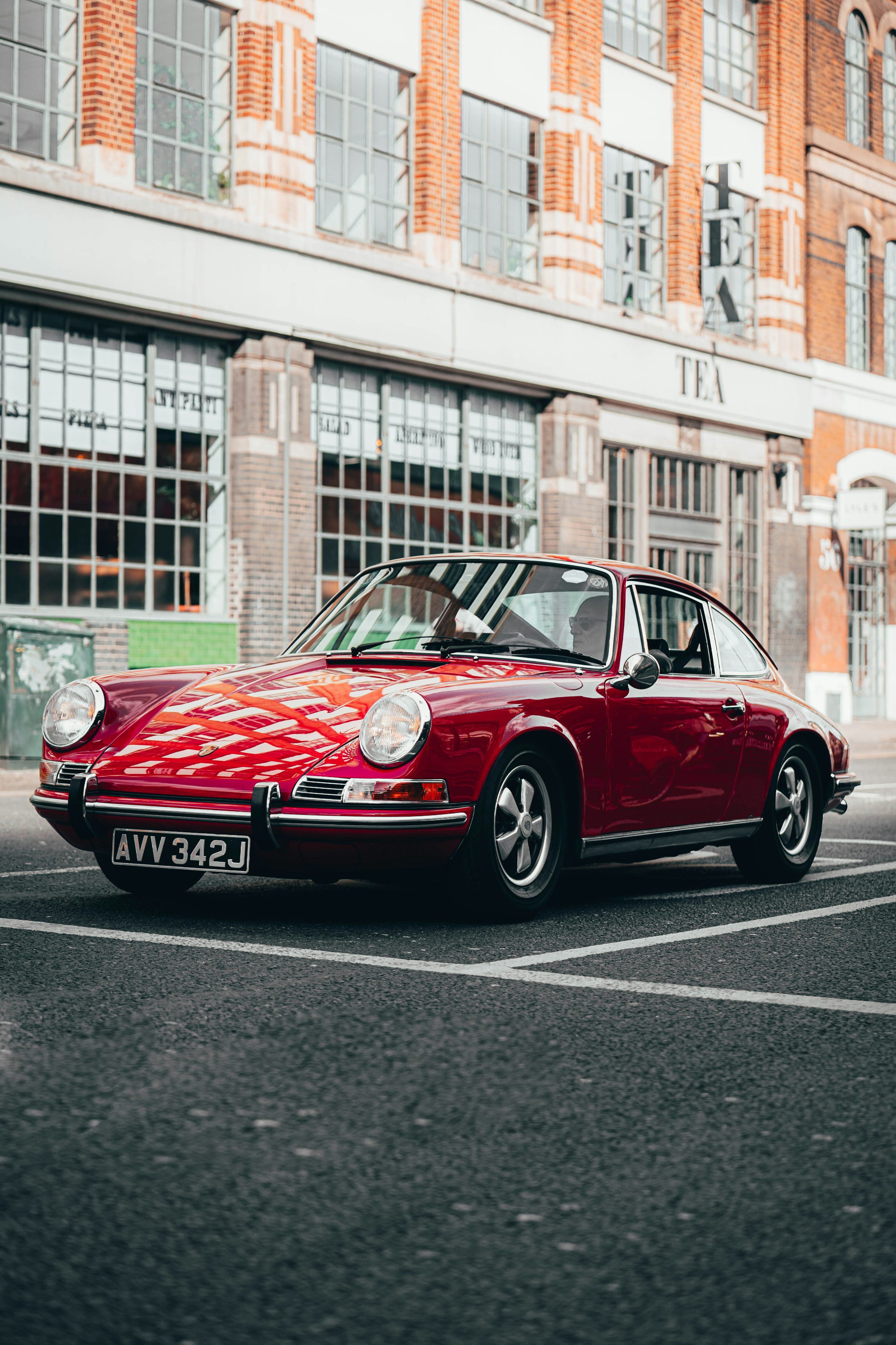 3000x4500 A red porsche parked on the side of the road