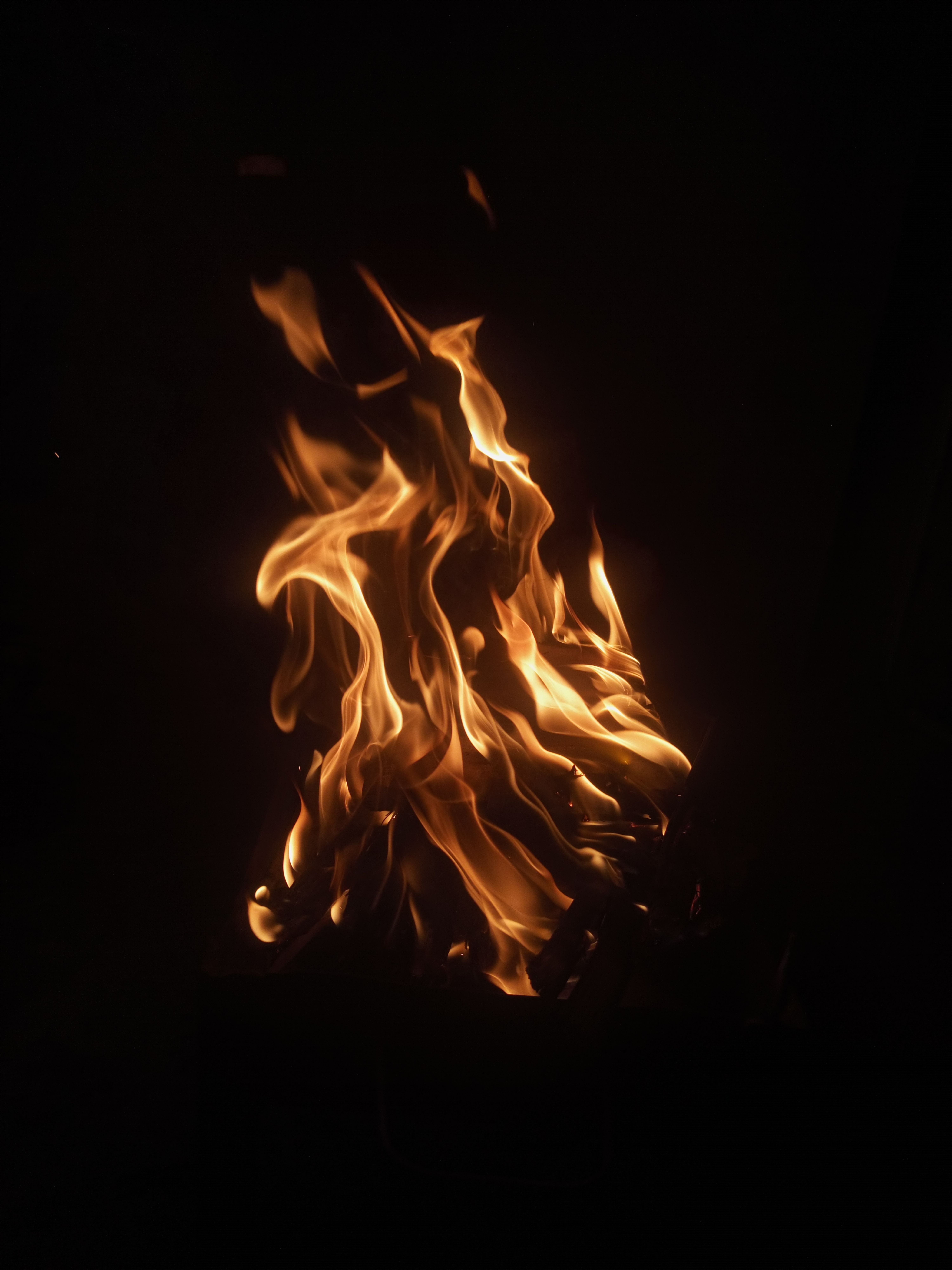 6000x8000 A fire is burning in the dark with a black background · Free