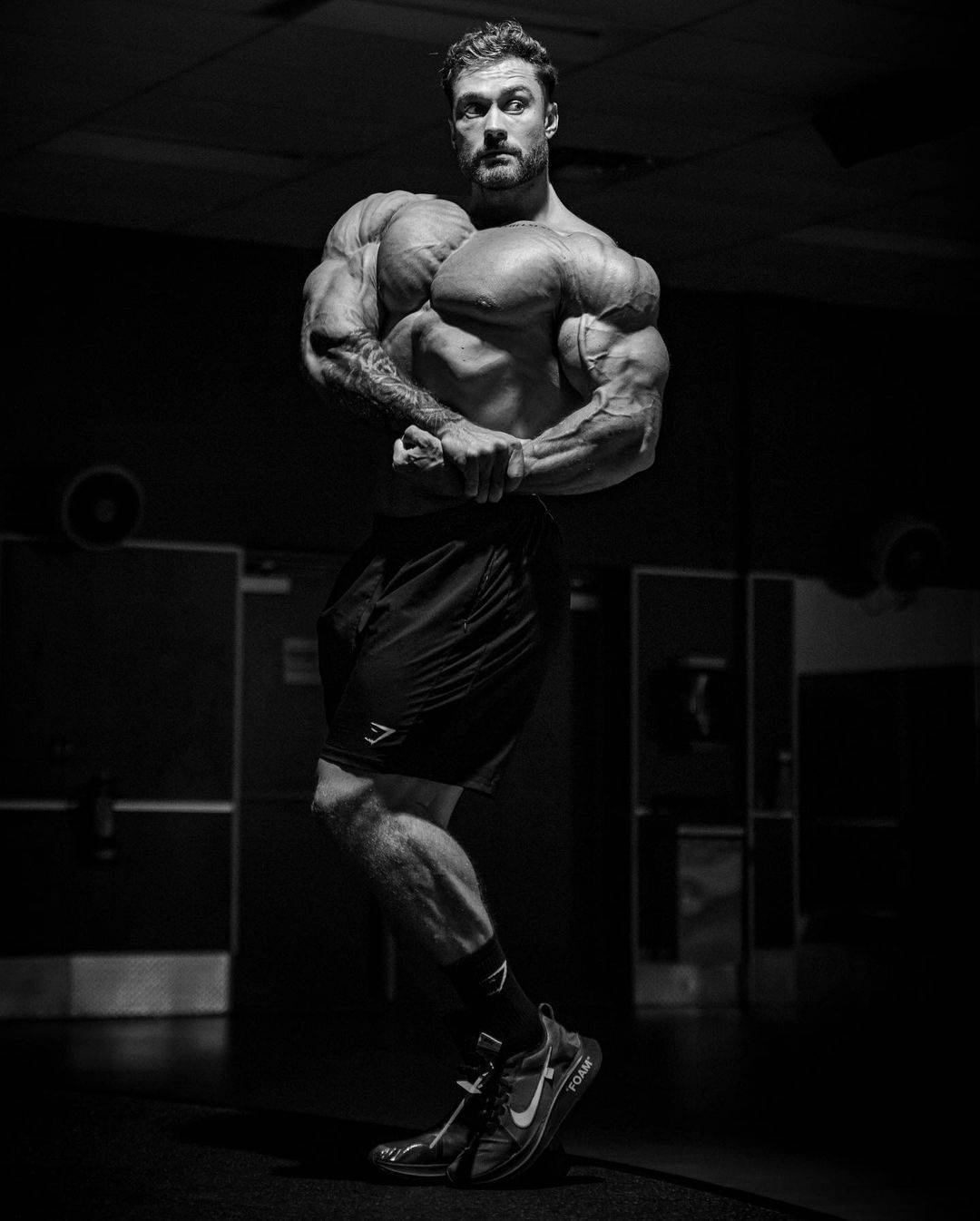 1080x1346 Download Chris Bumstead With Side Chest Pose Wallpaper