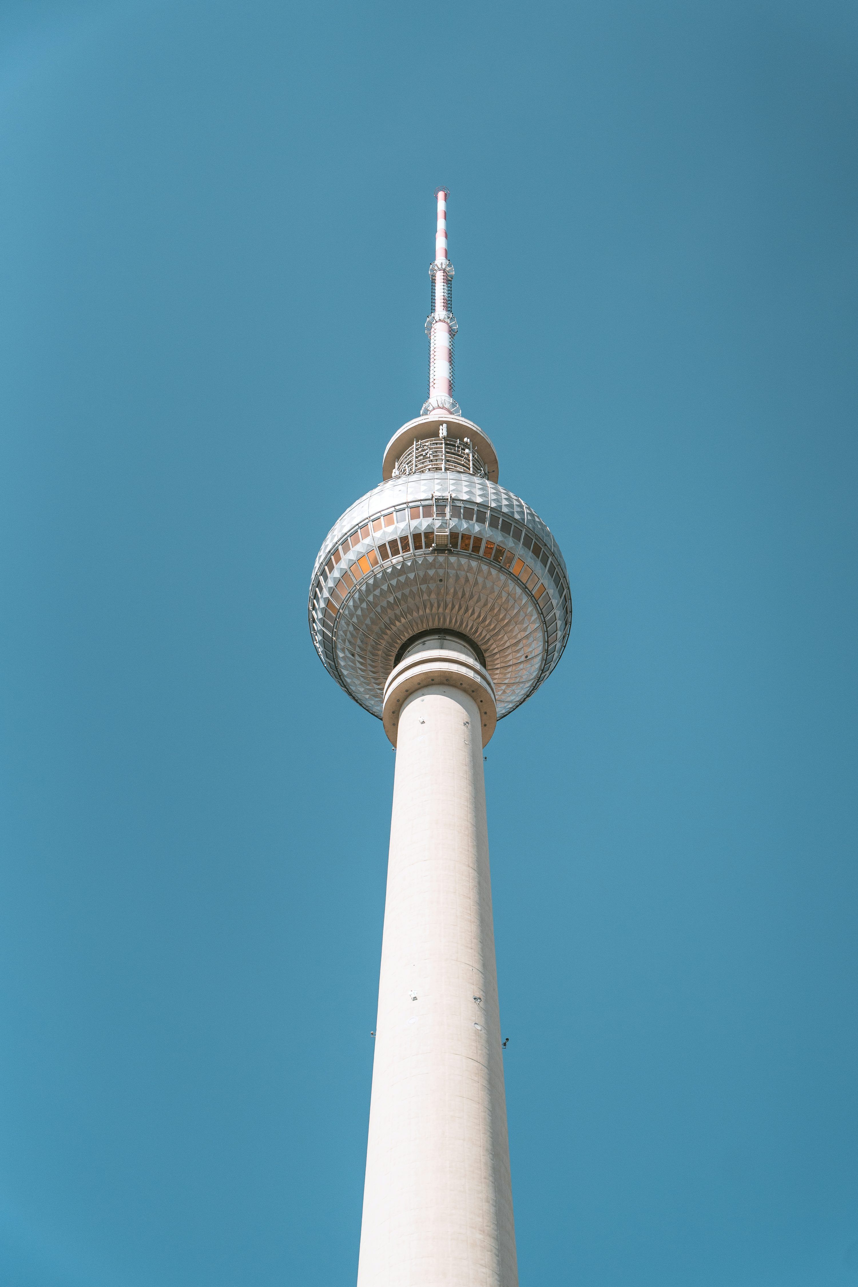 3000x4500 A tall tower with a circular top with Fernsehturm Berlin in the background