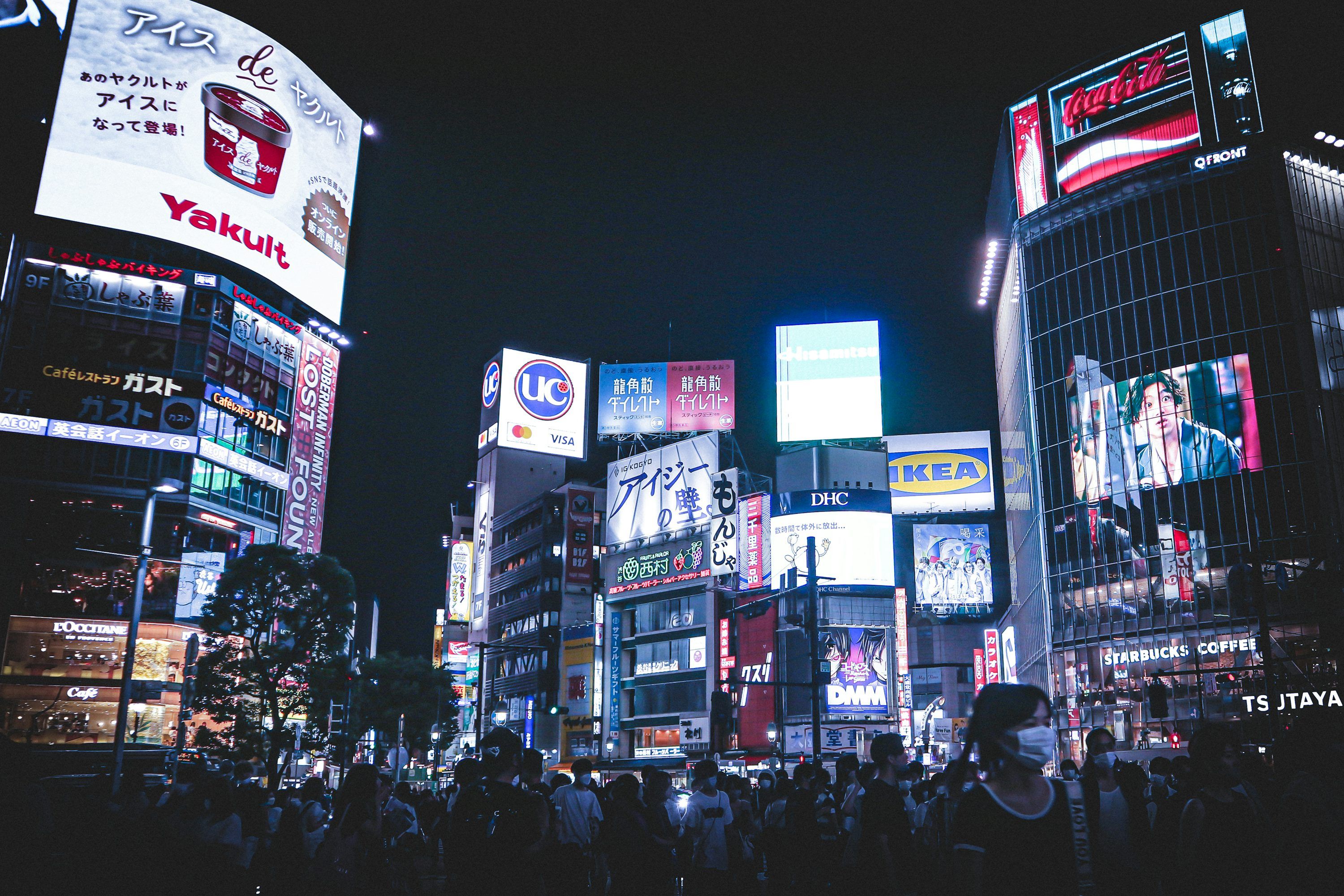 3000x2002 A crowd of people walking in a city at night