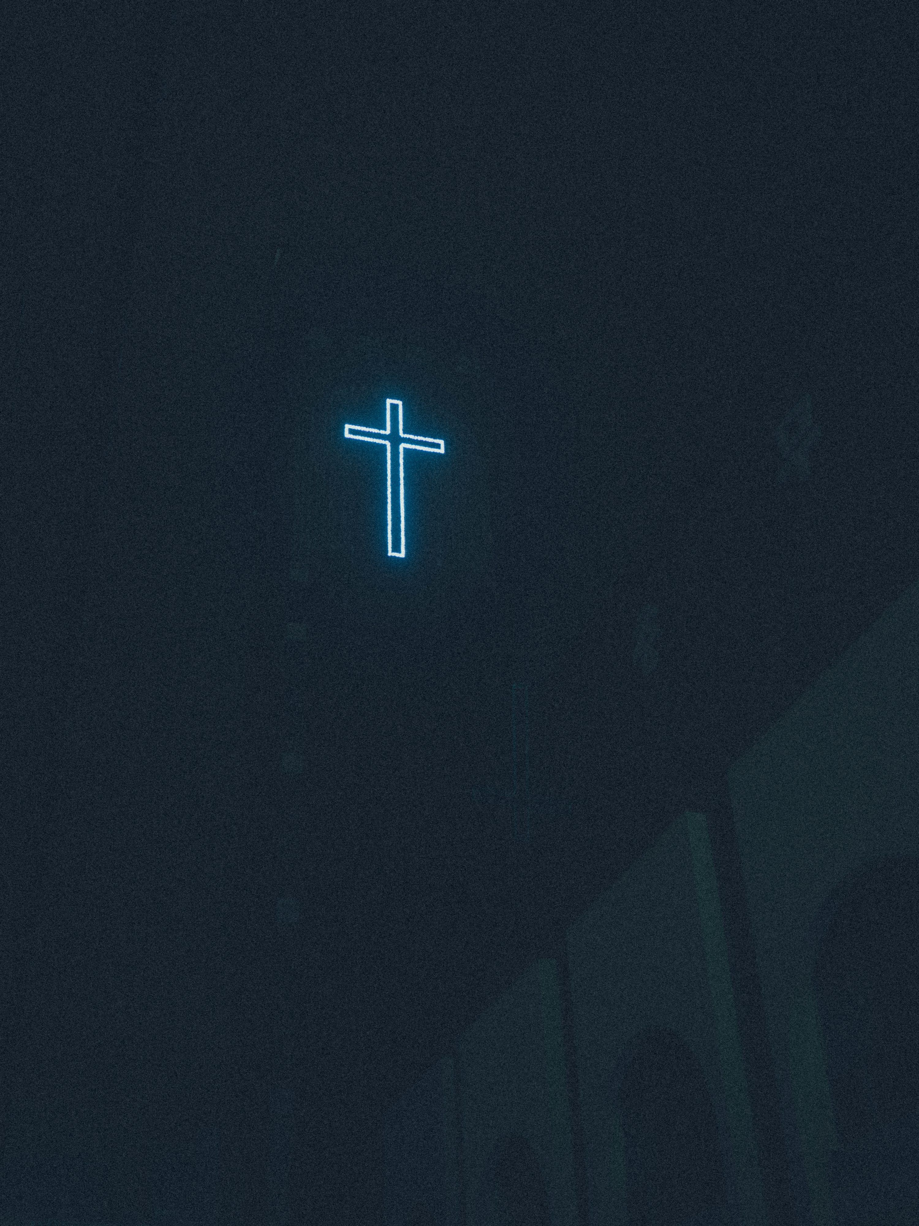 3000x4000 A neon cross glows in the dark