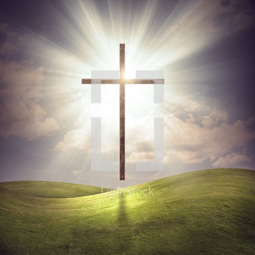 890x890 A large glowing cross over a grassy field with