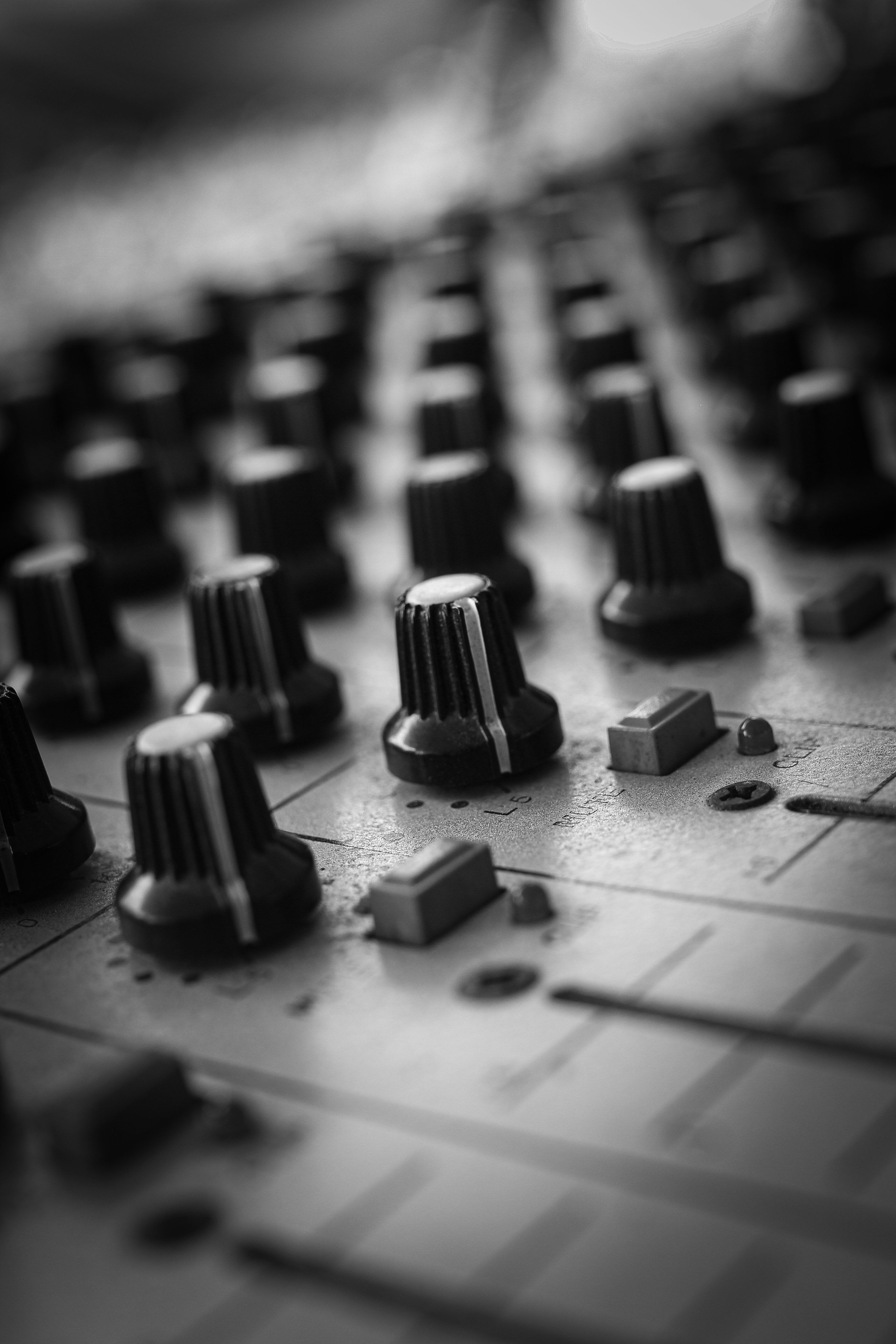 3000x4500 A close up of a mixing board with knobs