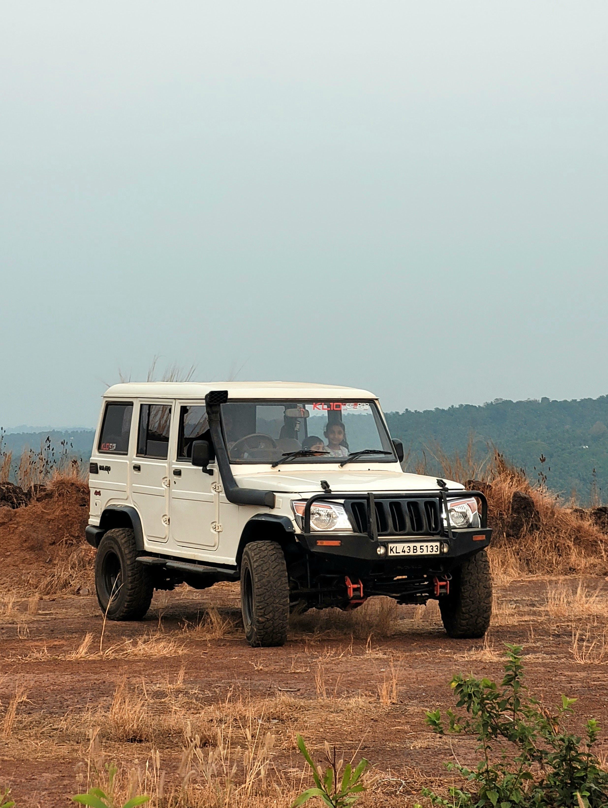 2471x3287 Children in White Mahindra Bolero · Free