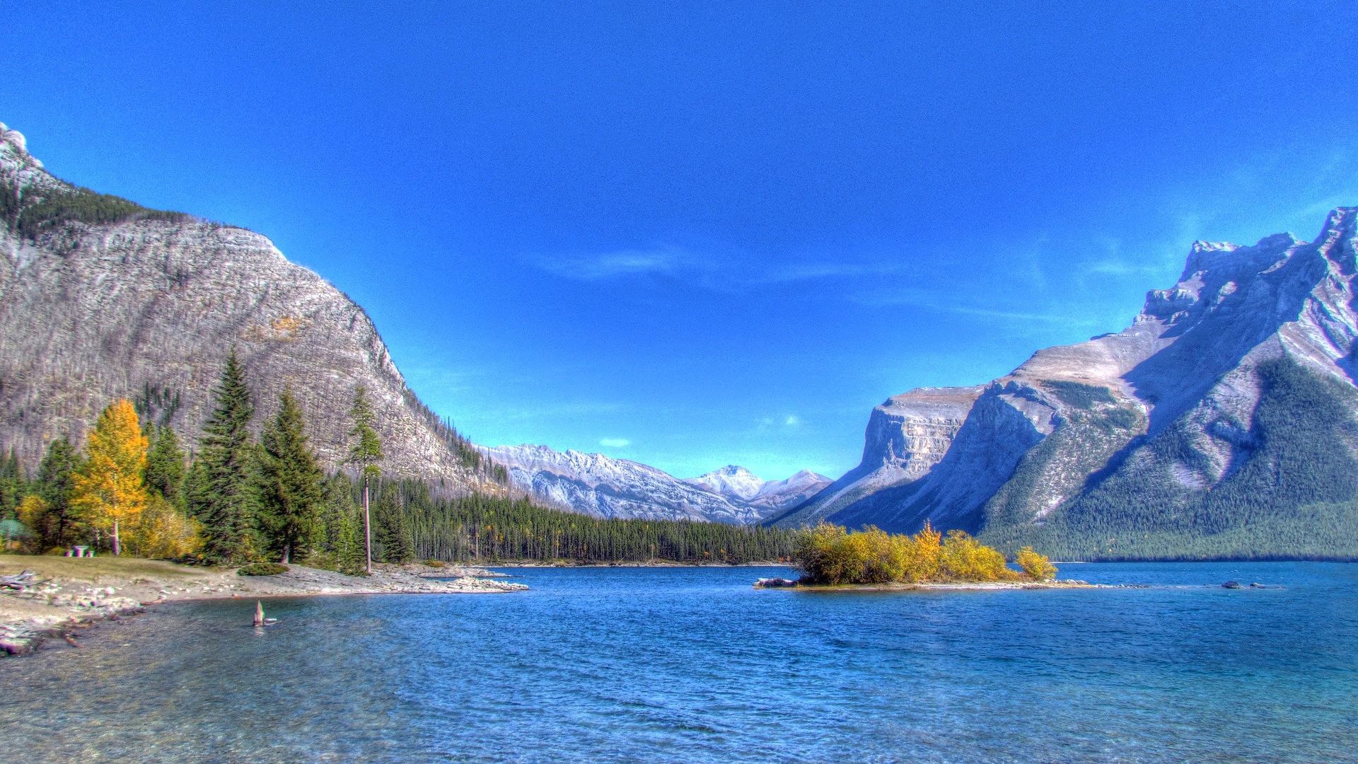 1920x1080 Beach River Surrounded Stone Mountains Under Blue Sky HD Nature Wallpaper