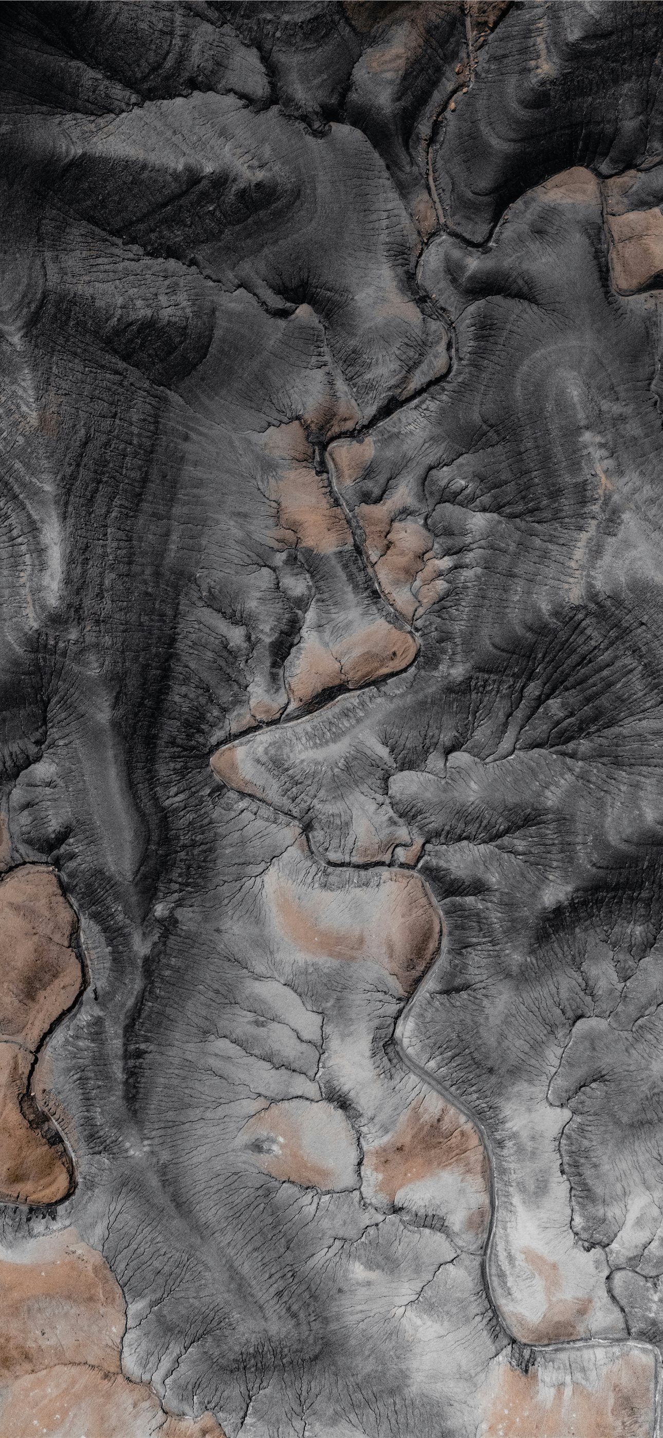1290x2796 Grey and tan rocky terrain in abstract view iPhone Wallpaper Free Download