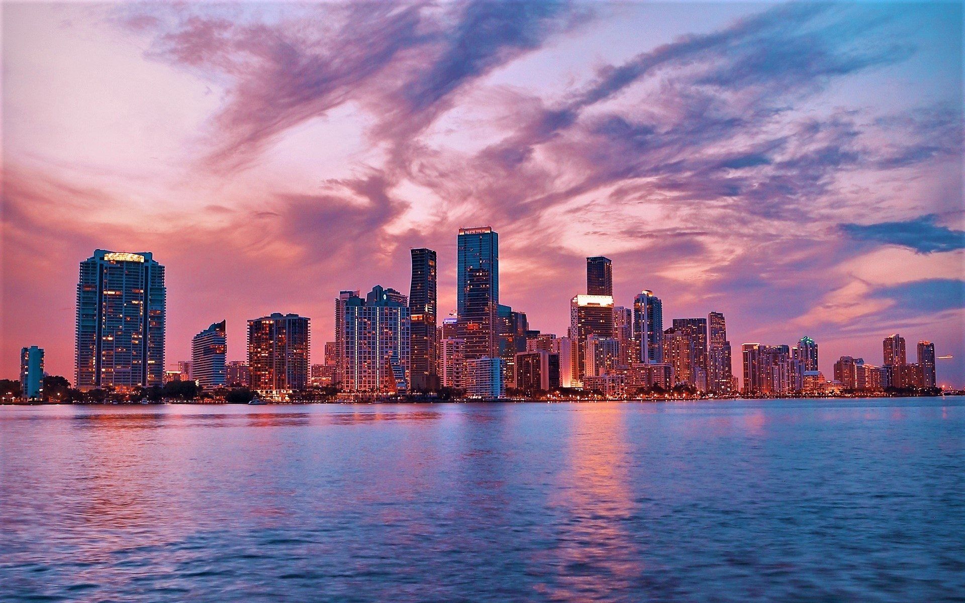 1920x1200 Miami Dusk Skyline: Illuminated Skyscrapers Over Calm Waters Wallpaperx1200
