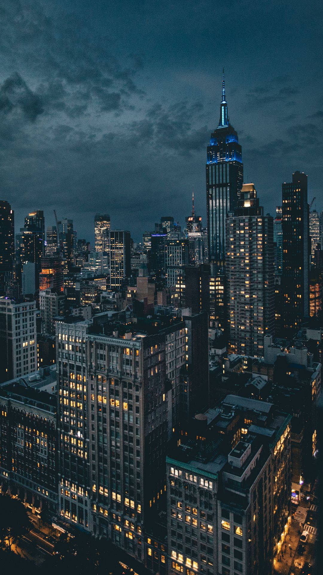 1080x1920 Download a cityscape at night with buildings and lights Wallpaper