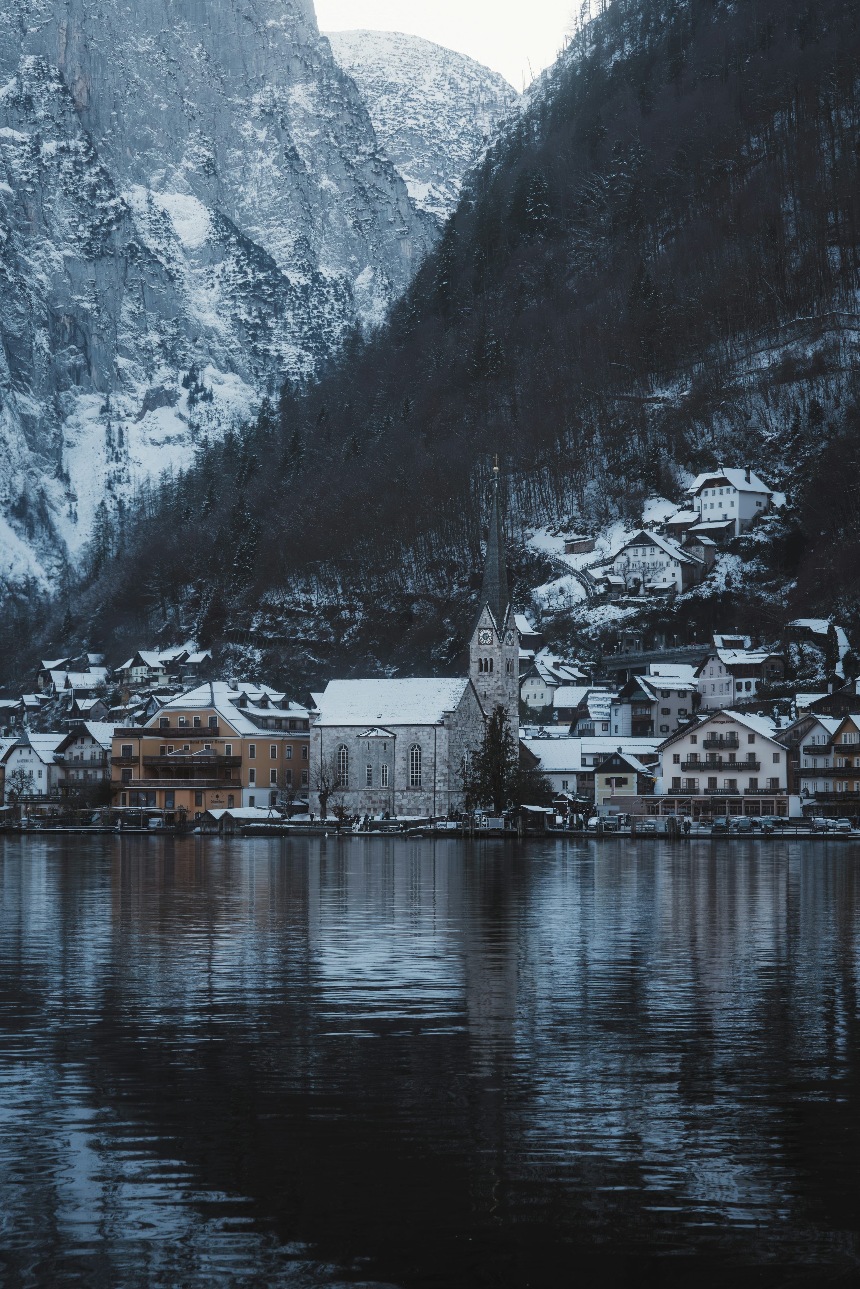 3000x4497 A village on a lake with mountains in the background