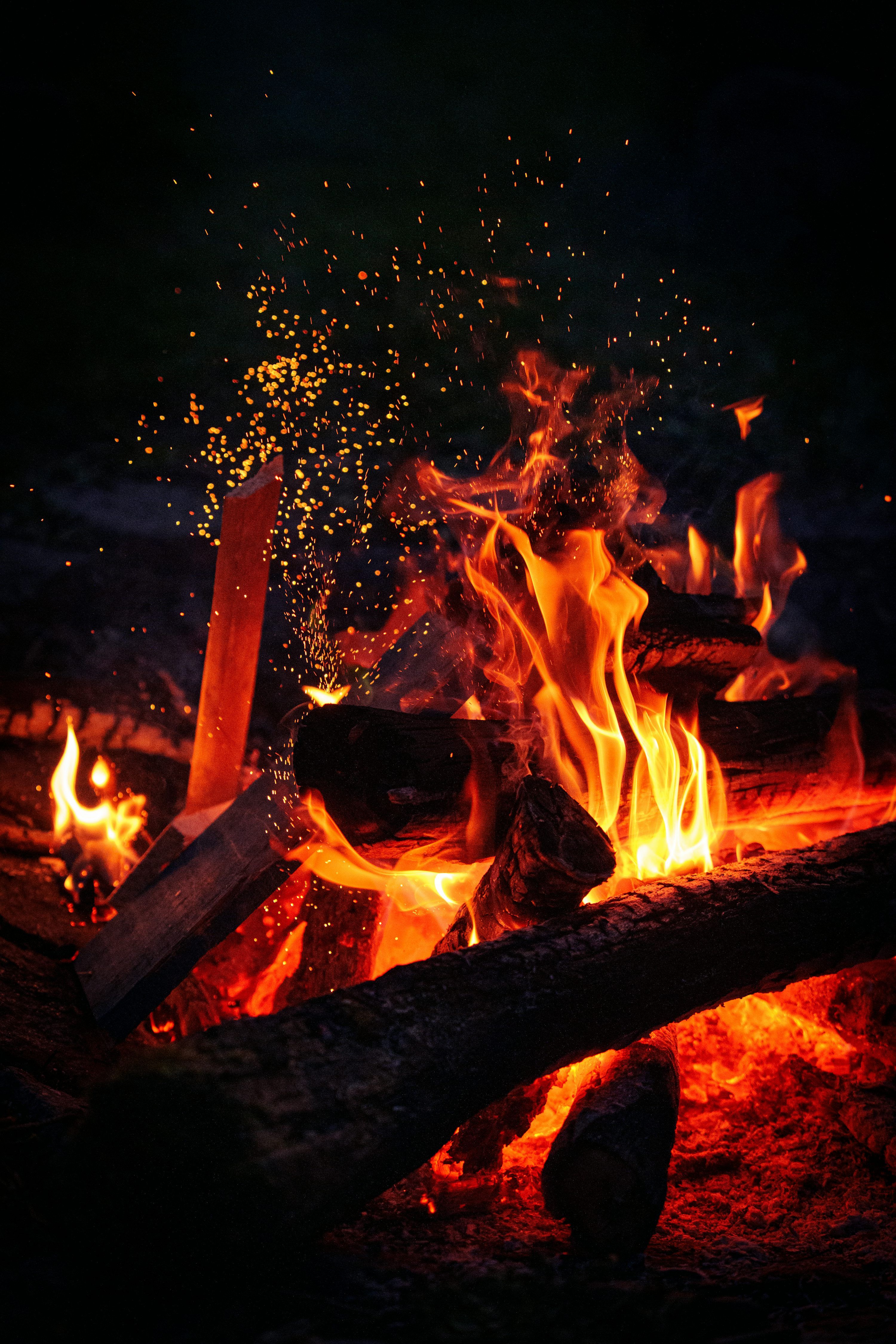 3000x4500 Campfire with vibrant flames and sparkling embers at night