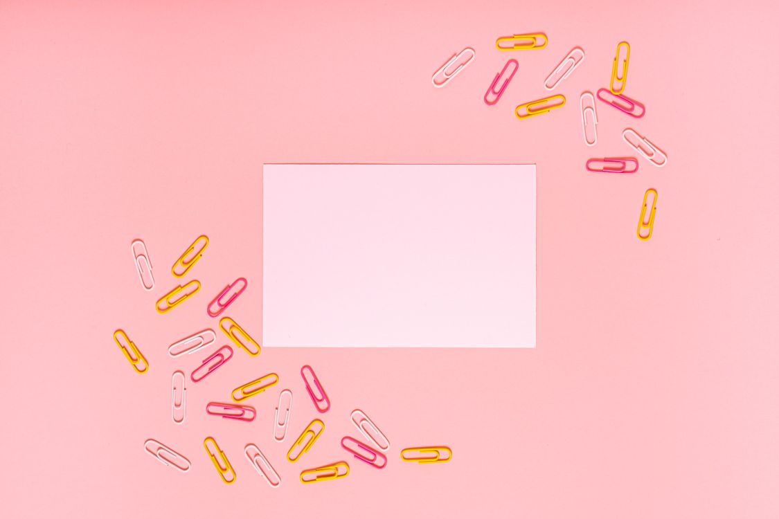 1125x750 Paper Clips and White Paper on Pink Background · Free