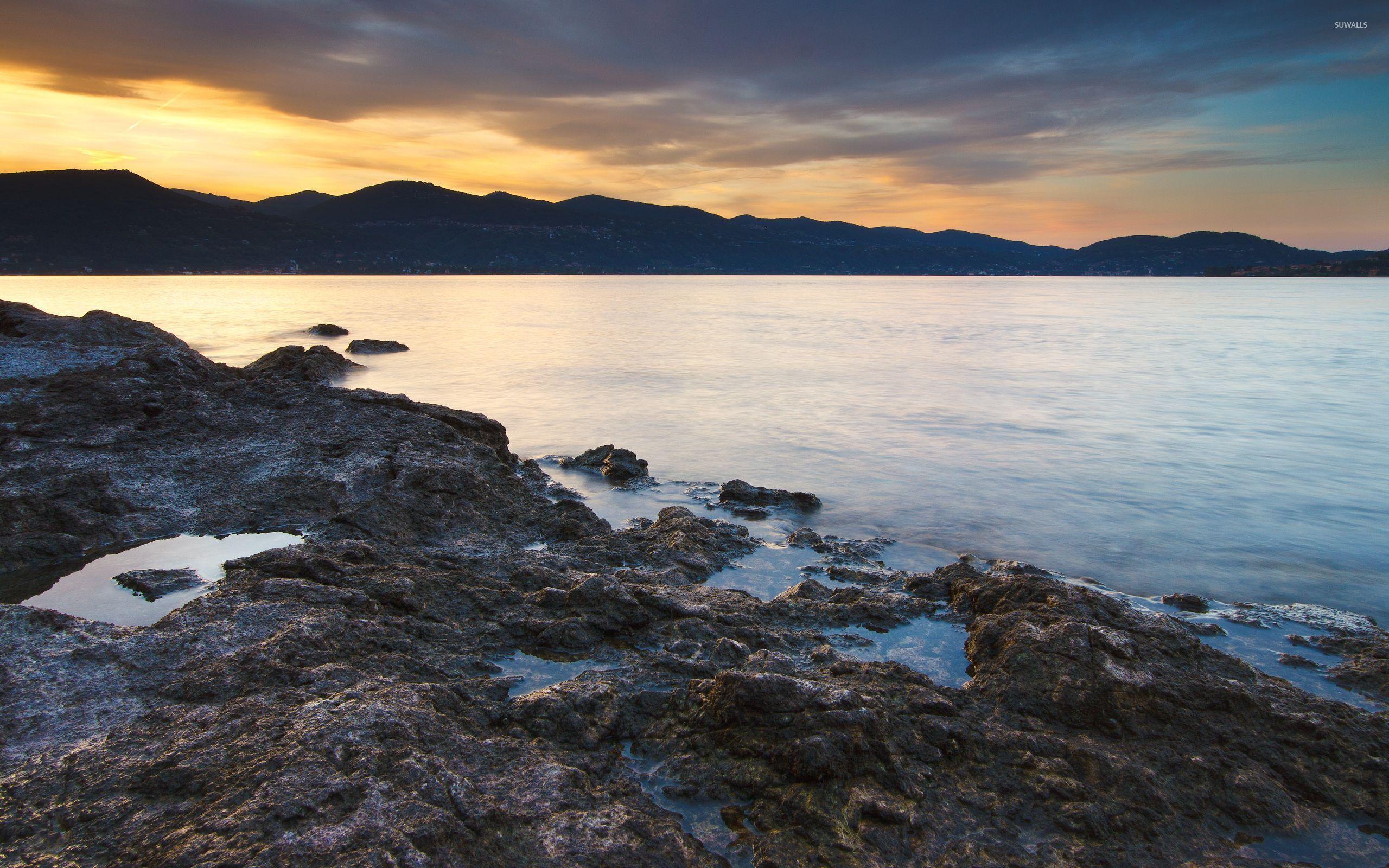 2560x1600 Golden sky behind the mountains by the water wallpaper wallpaper