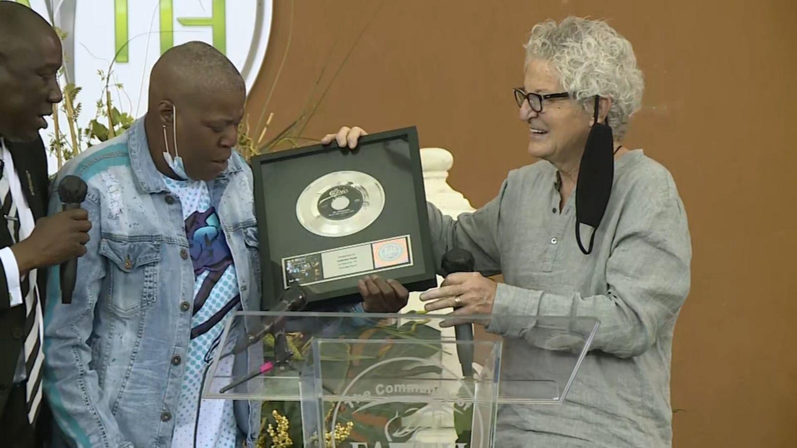 1600x900 REO Speedwagon presents Keep On Loving You RIAA plaque to George Floyd's sister during Houston prayer vigil