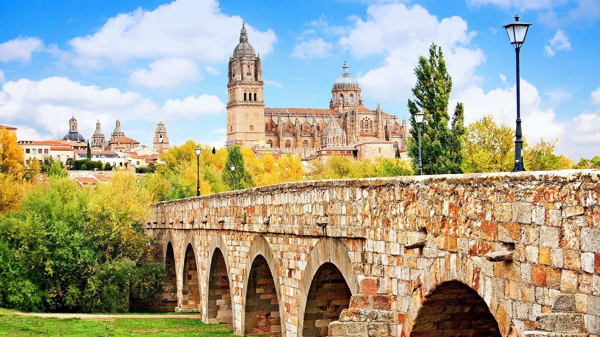1920x1080 Salamanca skyline with New Cathedral and Roman bridge, Madrid, Spain. Windows 10 Spotlight Image