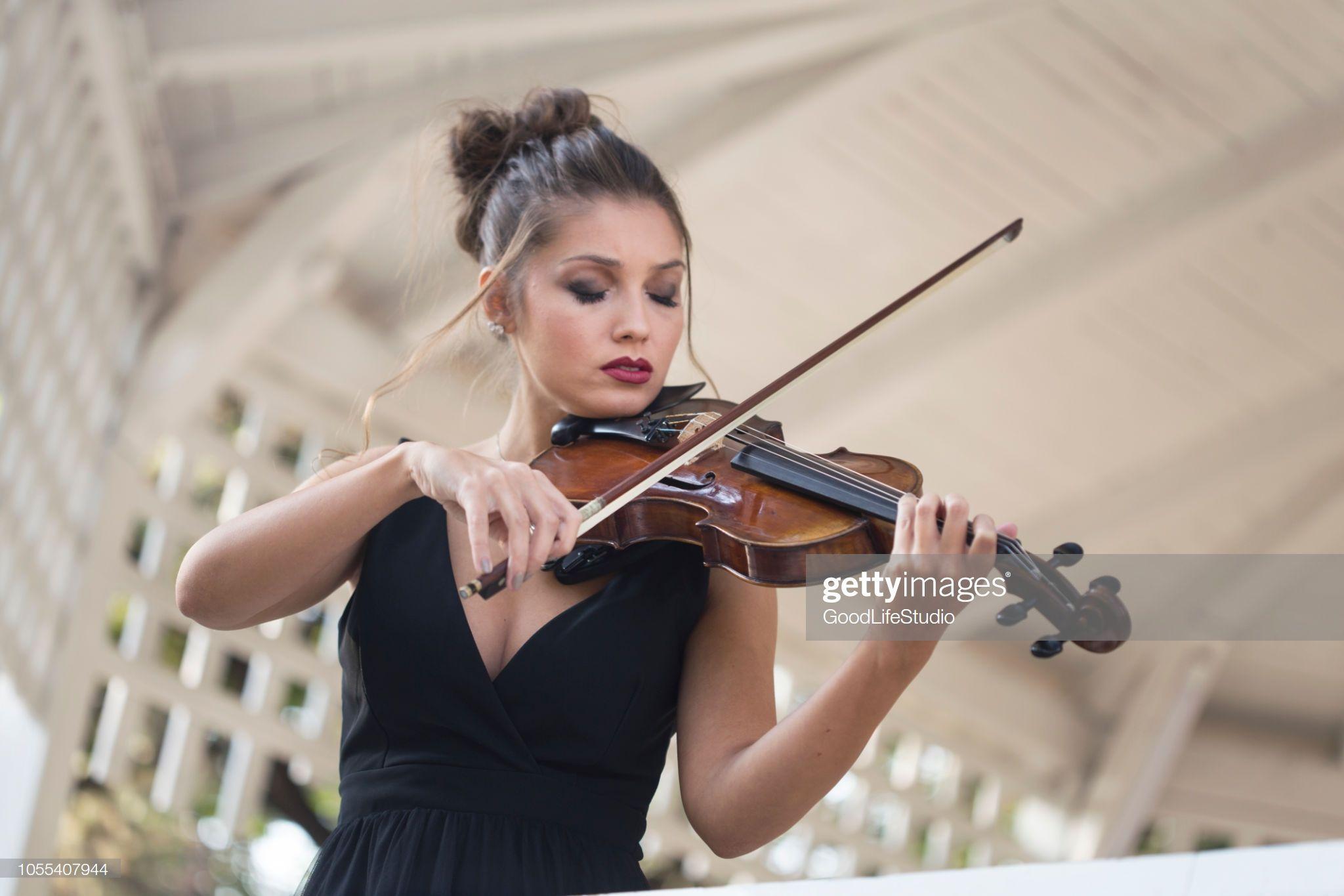 2048x1365 Female violinist playing a violin outdoors in a music pavilion or. Violinist photography, Violin photography, Violinist