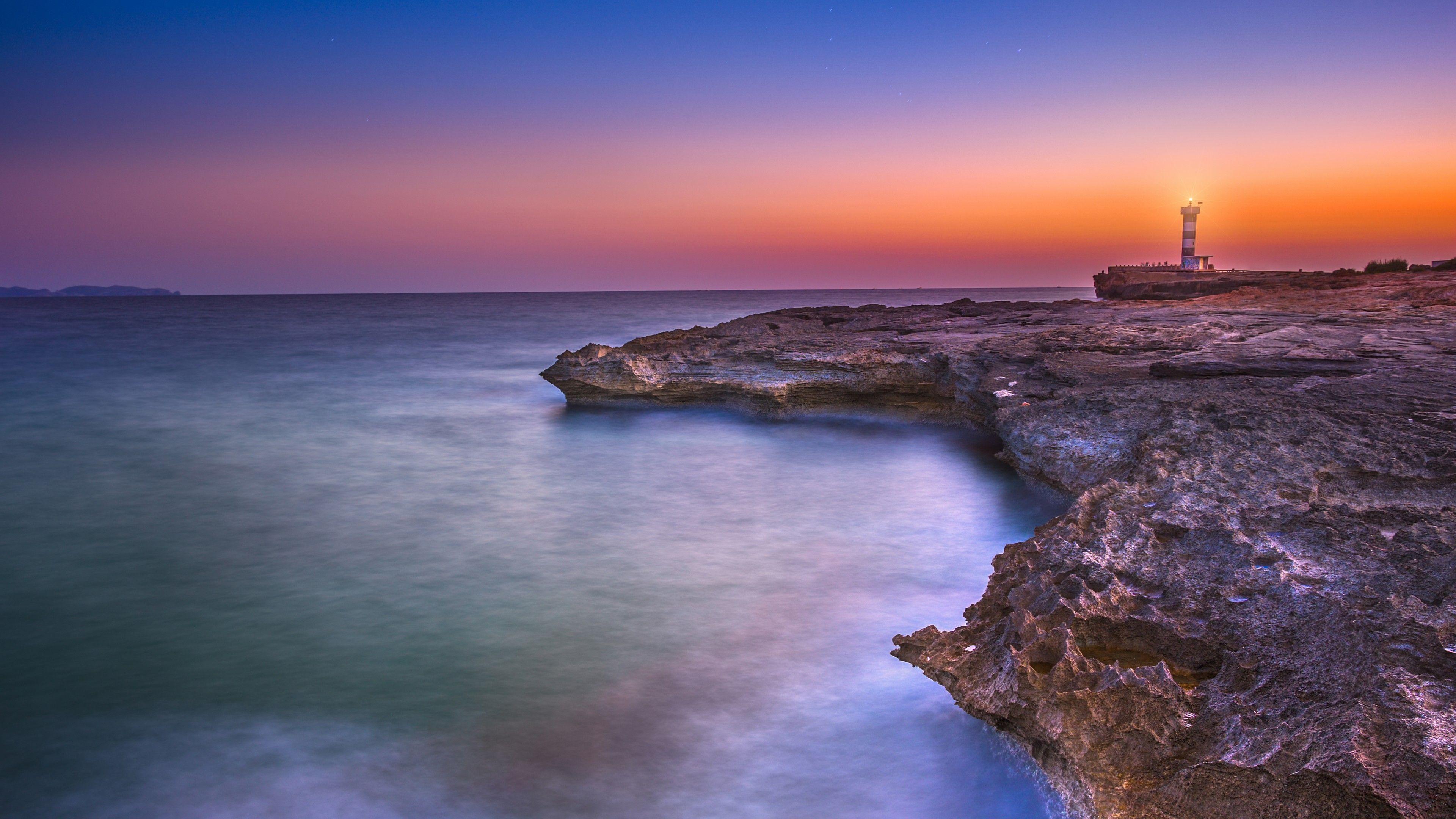3840x2160 Lighthouse Sunset Rocky coast 5K Wallpaper