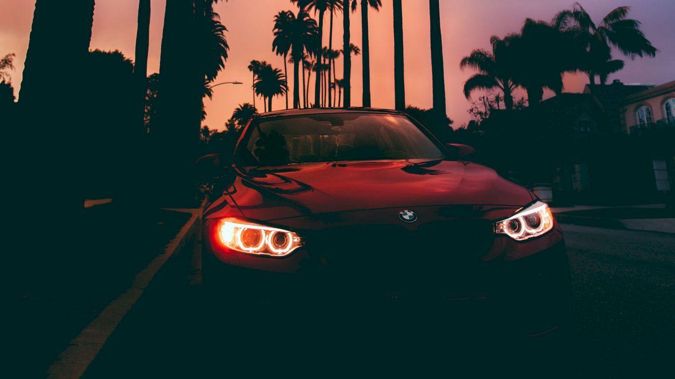 1366x768 Download wallpaper 1366x768 bmw bmw, sunset, front view, palm trees tablet, laptop HD background