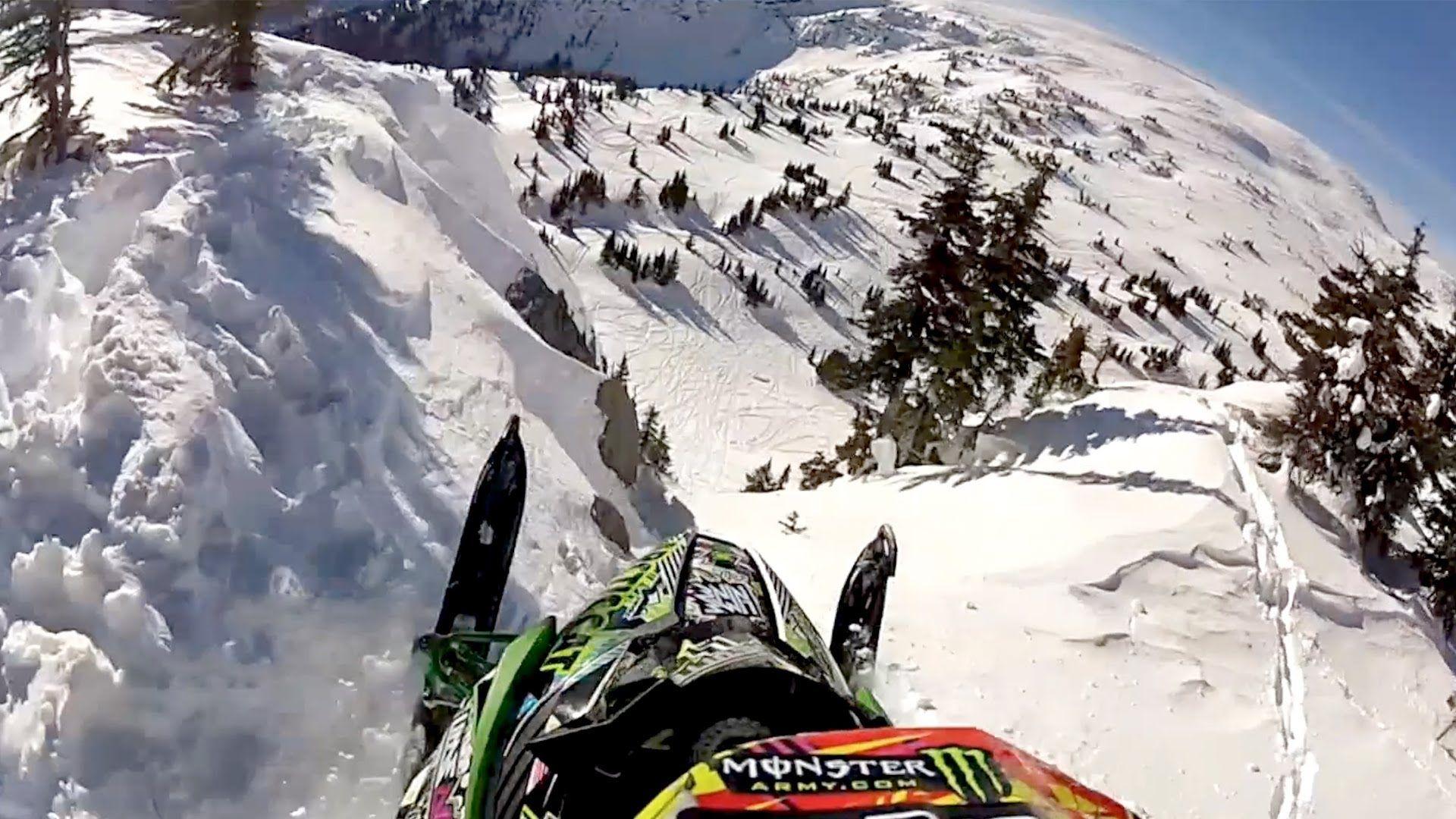 1920x1080 GoPro Video of a Snowmobile Getting Some Serious Air While Going Down the Side of a Cliff