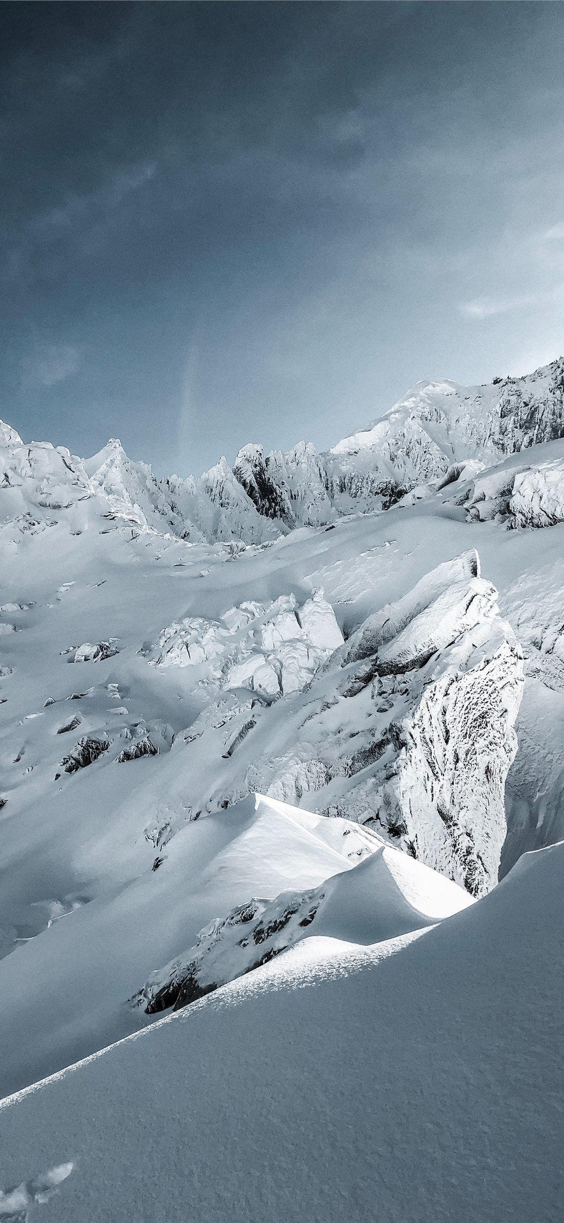 1125x2436 snow covered mountain under blue sky during daytim. #mountain #nature #snow #grey #mountains #france. Winter landscape, Landscape wallpaper, Scenery background
