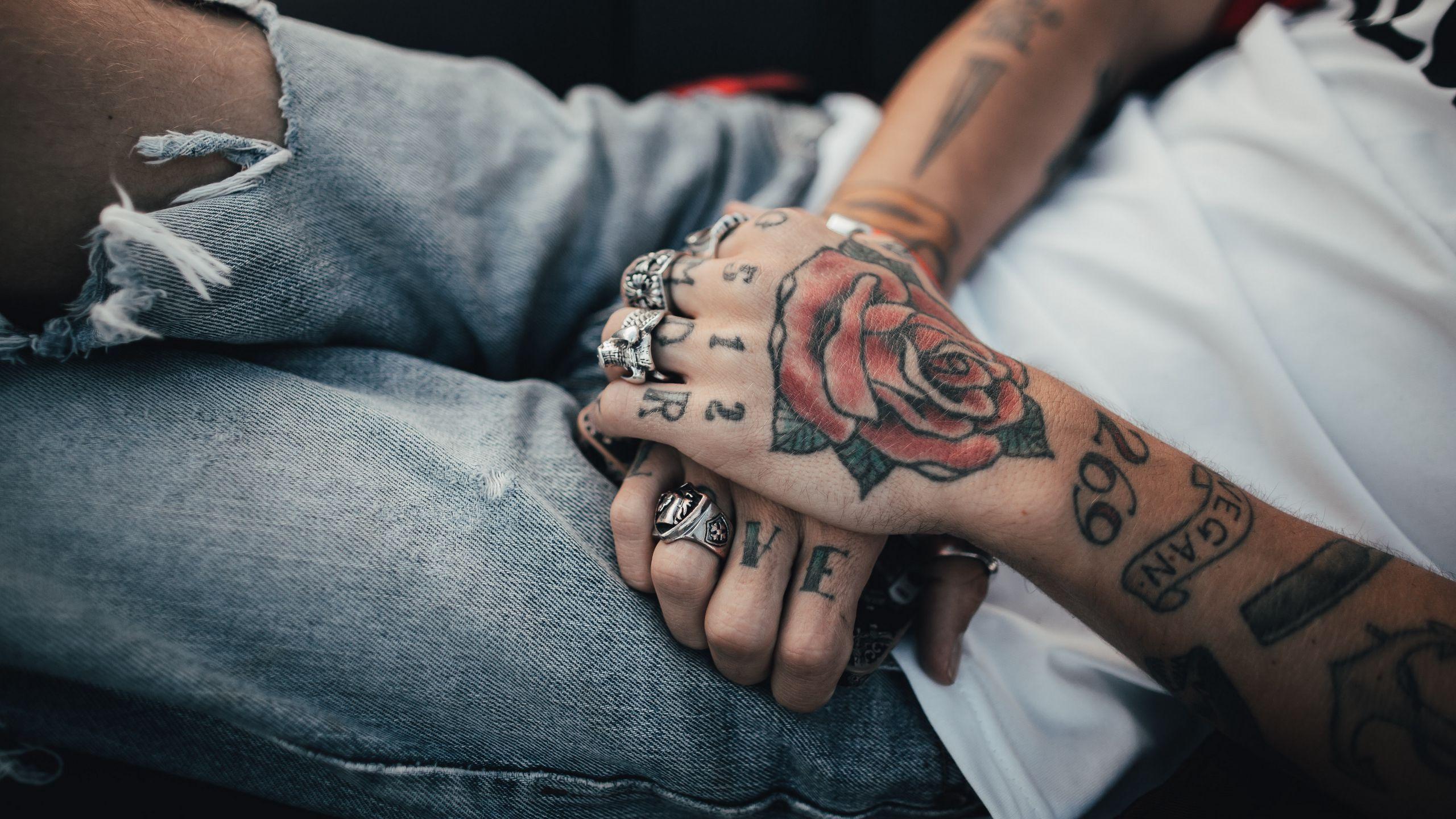 2560x1440 Download wallpaper 2560x1440 hands, tattoos, rings, decorations widescreen 16:9 HD background