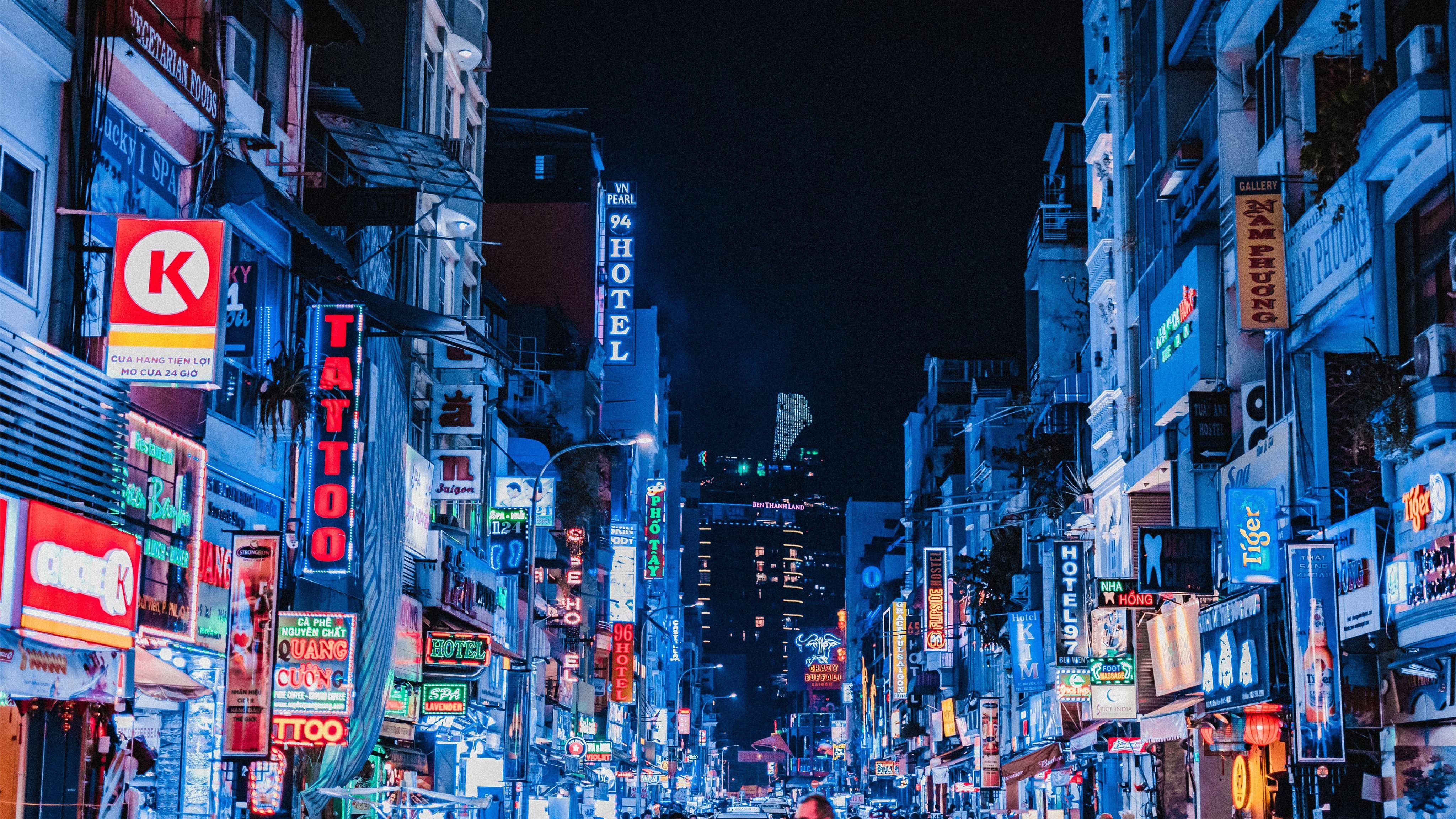 4096x2304 people between city buildings at night MacBook Air Wallpaper Download