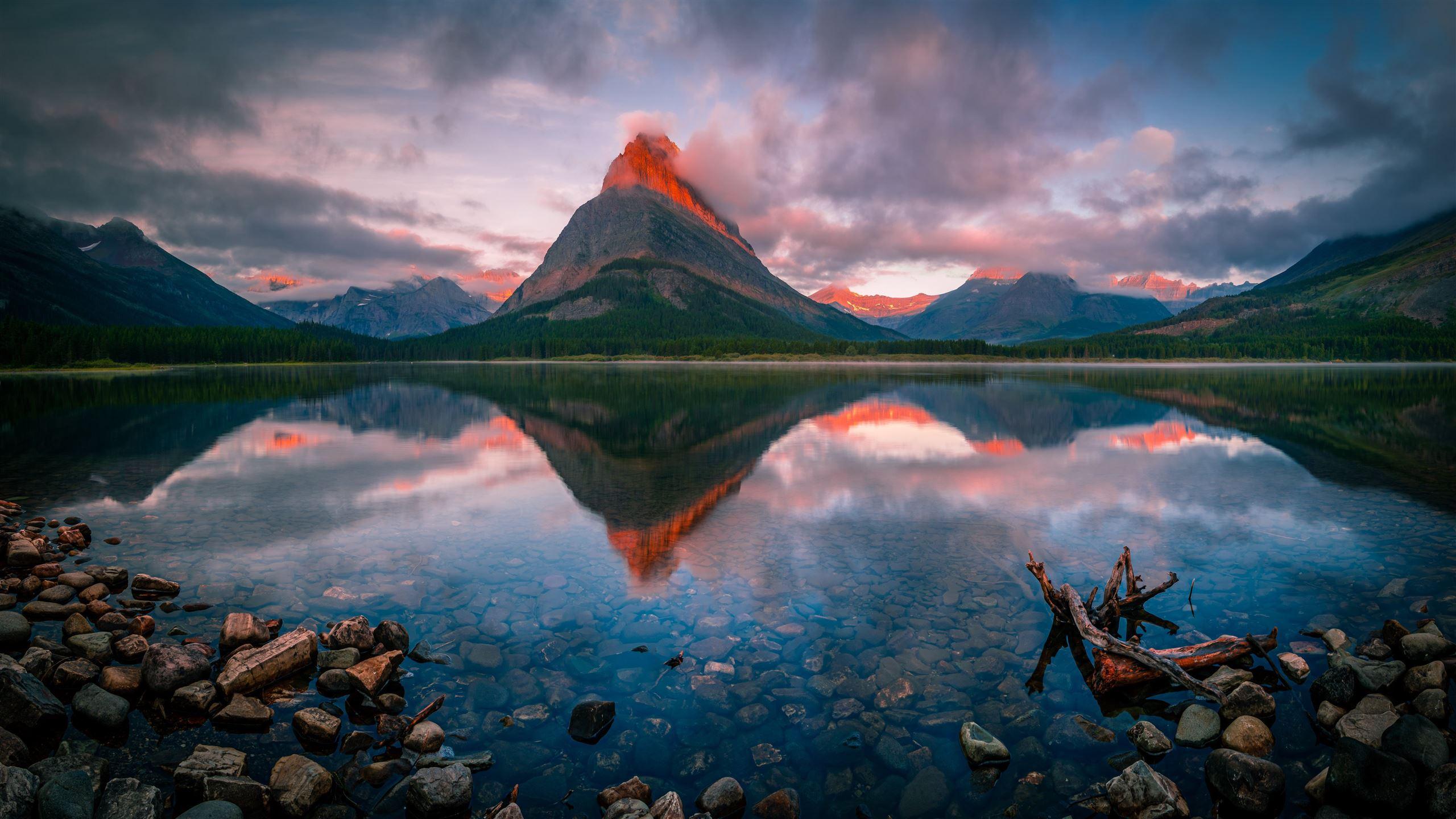 2560x1440 surreal sunrise at the swiftcurrent lake 5k MacBook Air Wallpaper Download