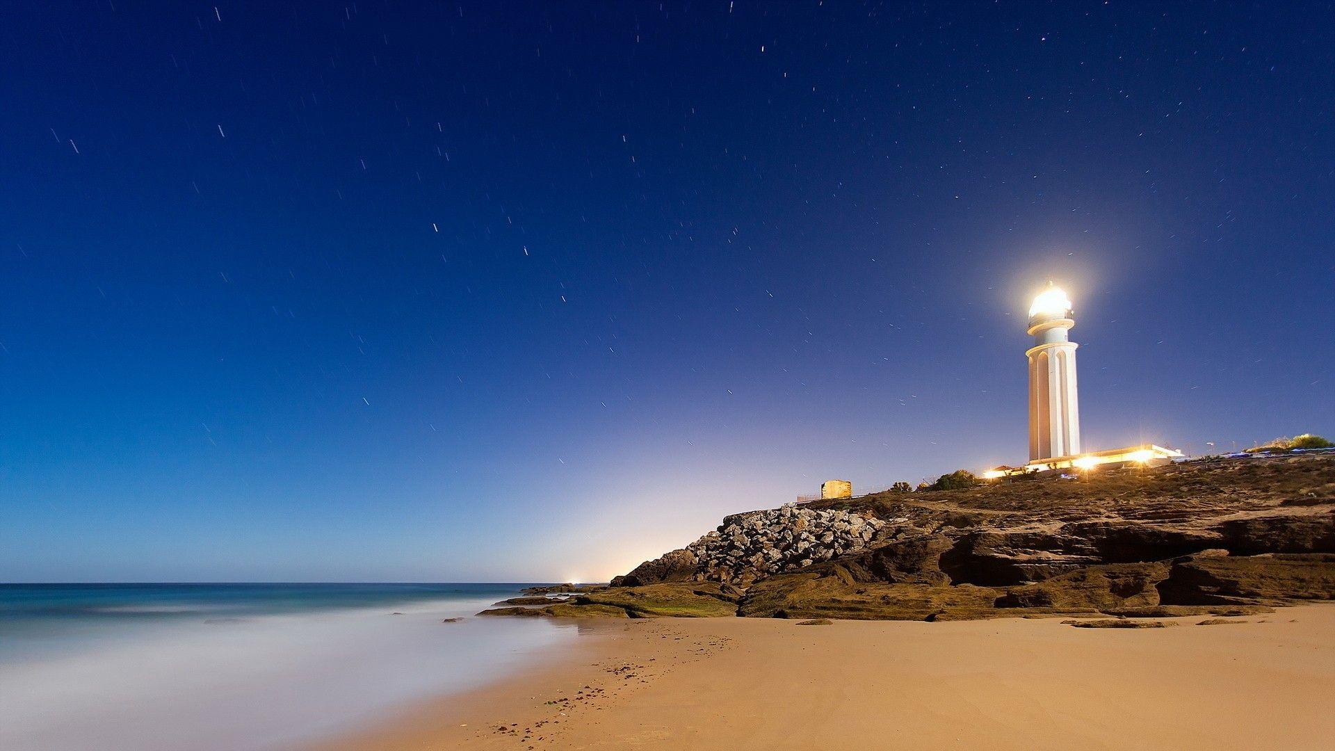 1920x1080 Bright lighthouse at night wallpaper. Lighthouse, Travel wallpaper, Trafalgar