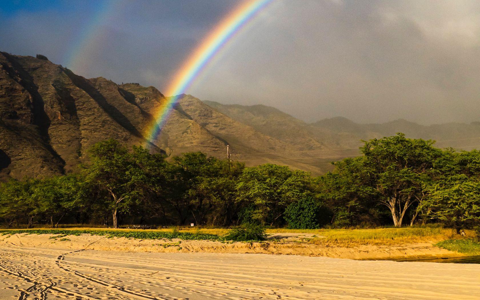1680x1050 Download wallpaper 1680x1050 rainbow, beach, mountain, trees, sand widescreen 16:10 HD background