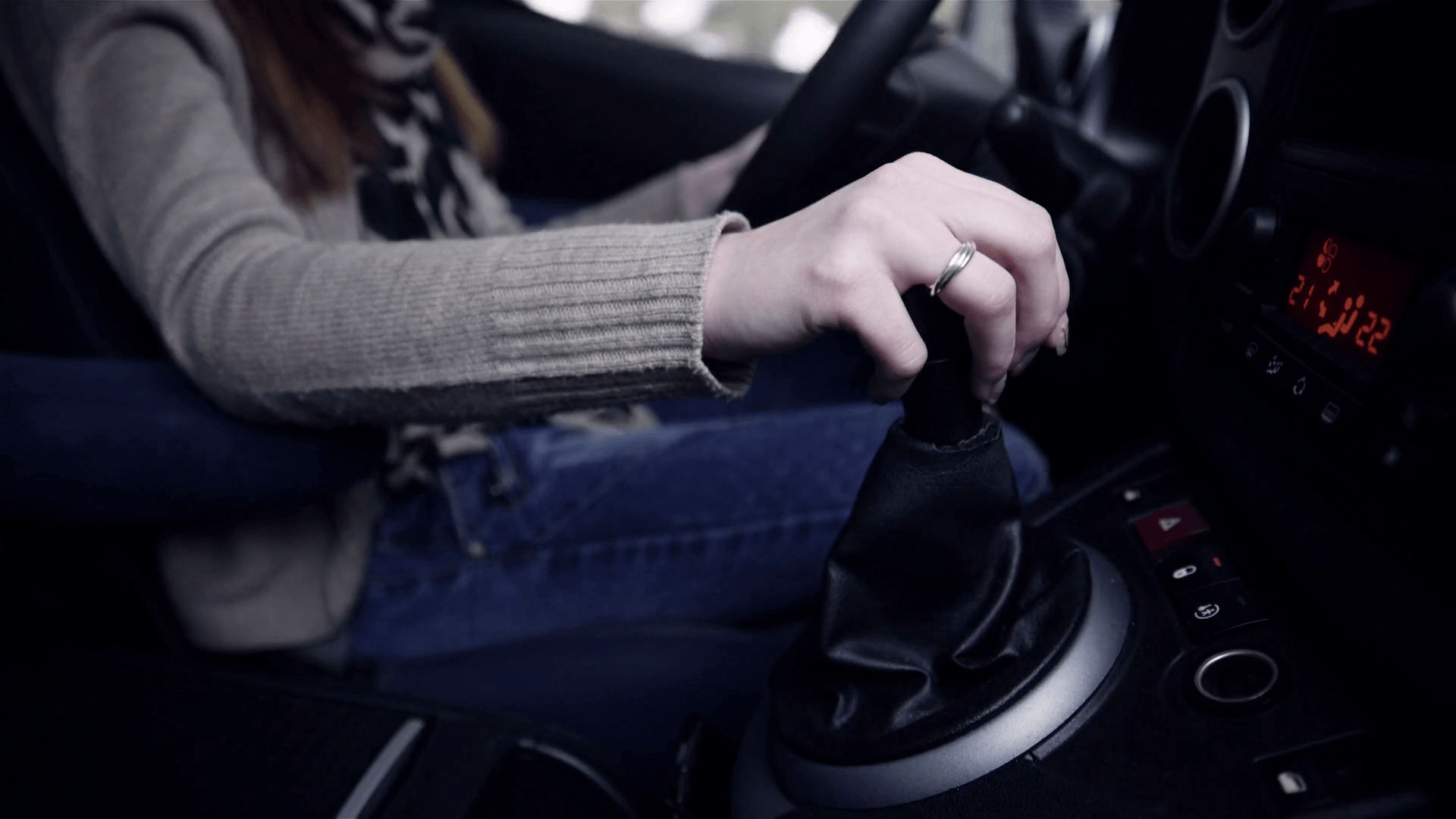 1920x1080 Car gear change dashboard upper view 4K. Female hand holding gear handle, getting ready to change speed gear close up. Stock Video Footage