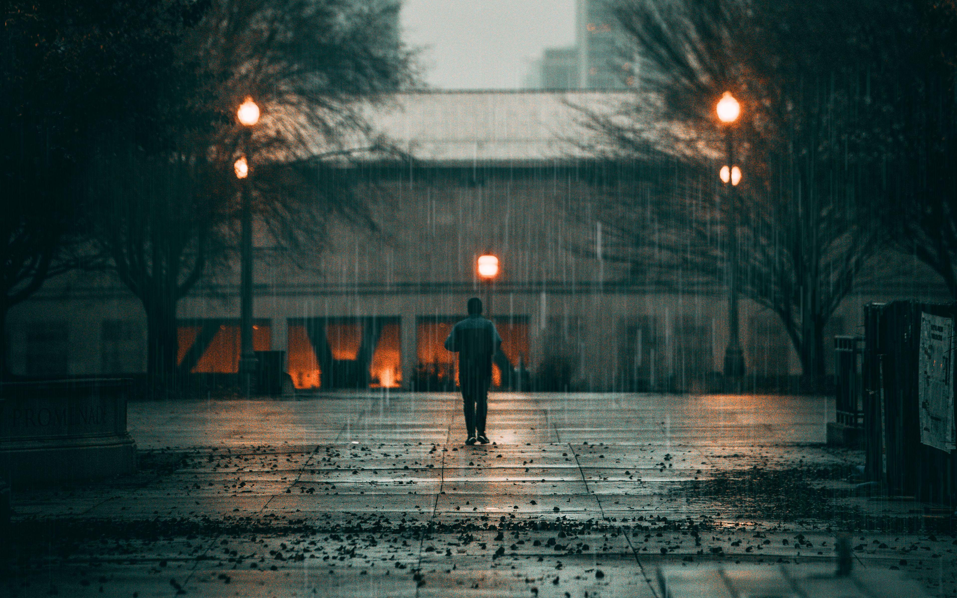 3840x2400 Download wallpaper 3840x2400 man, rain, loneliness, sad, walk, street, city 4k ultra HD 16:10 HD background