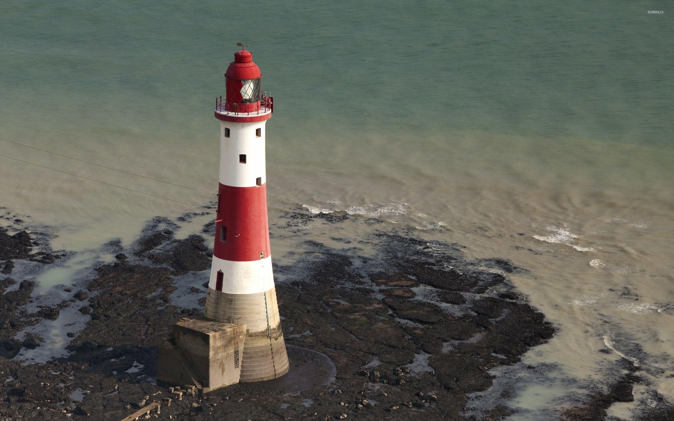 2560x1600 Red and white lighthouse surrounded by water wallpaper wallpaper