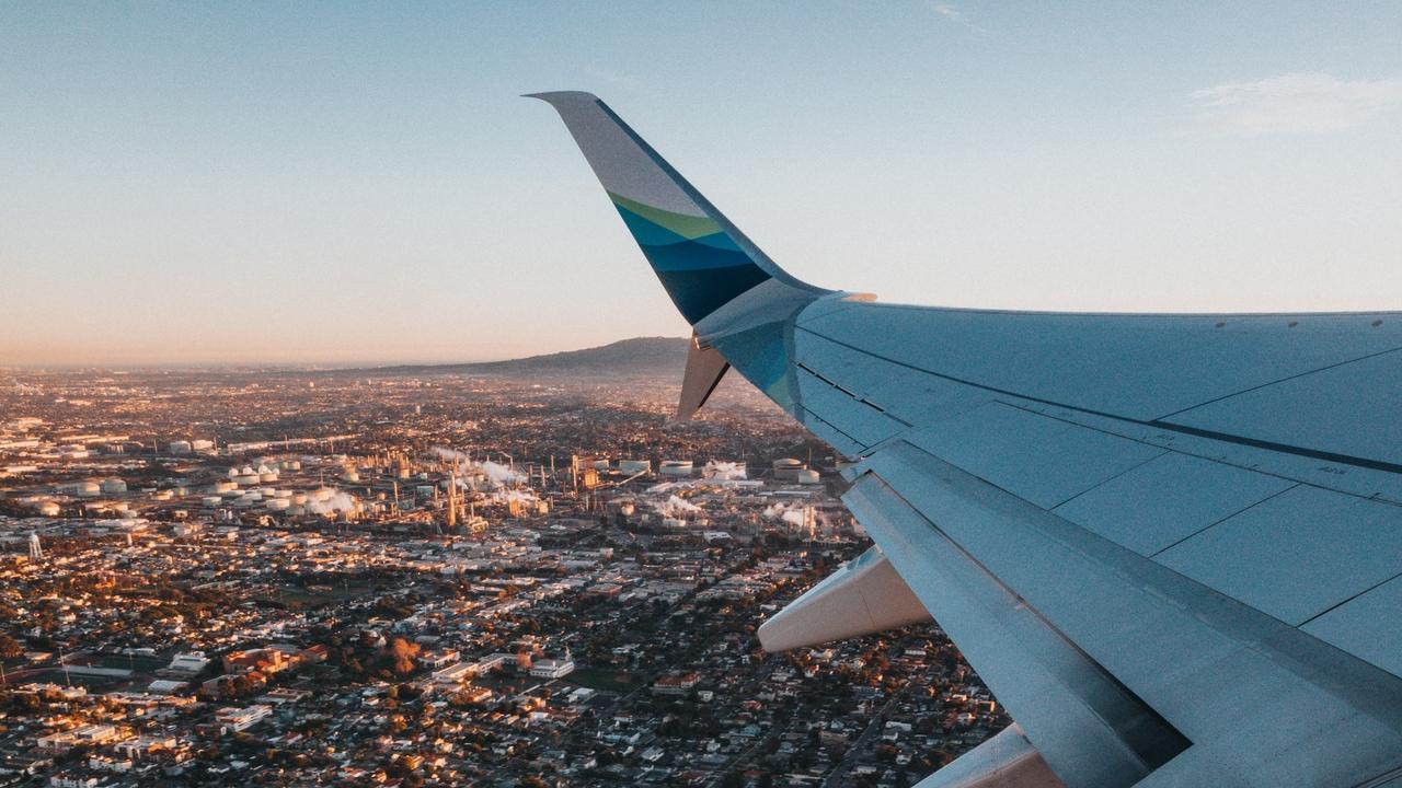 1280x720 Wallpaper airplane wing overview city aerial view
