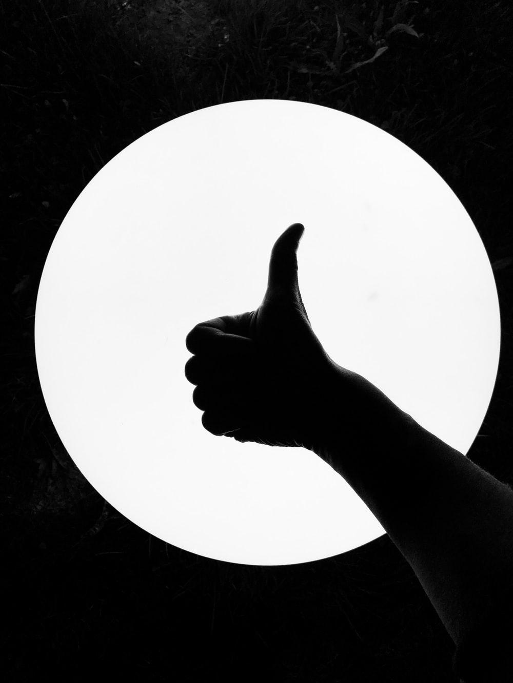 1000x1333 persons hand on white round board photo
