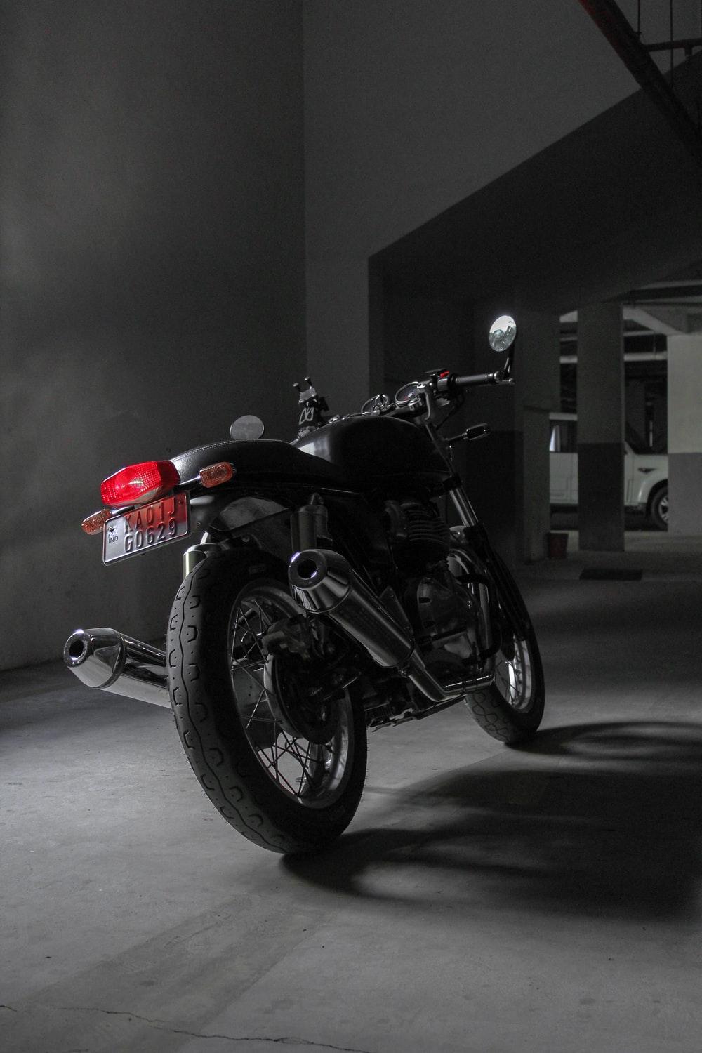 1000x1500 black and red motorcycle parked on gray pavement photo