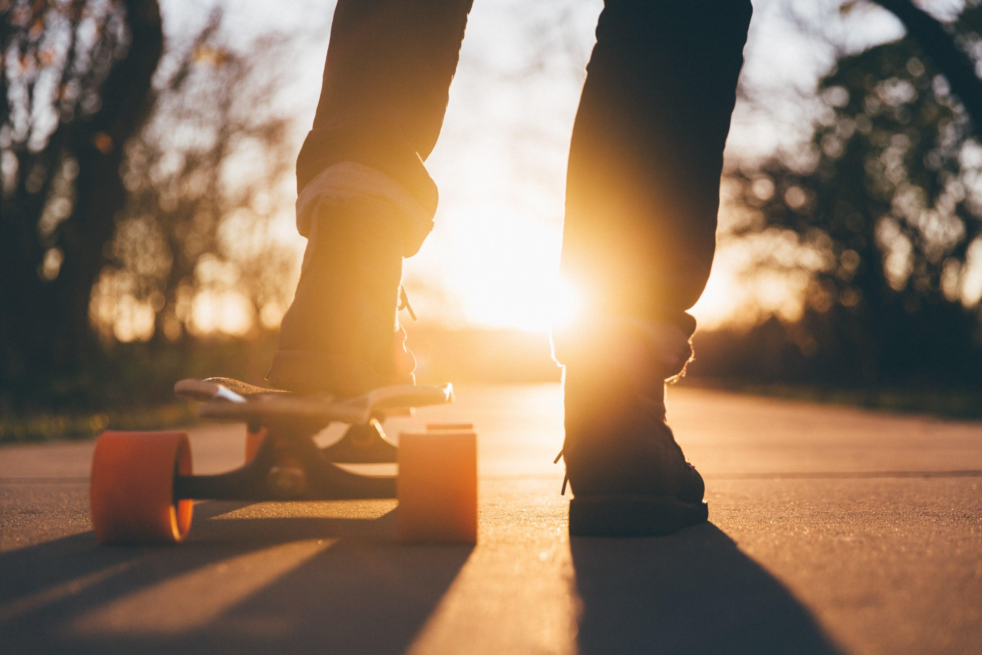 3840x2560 Wallpaper / the silhouette of a person riding a skateboard with orange wheels at sunset at university of northern iowa, northern iowa skateboarder 4k wallpaper