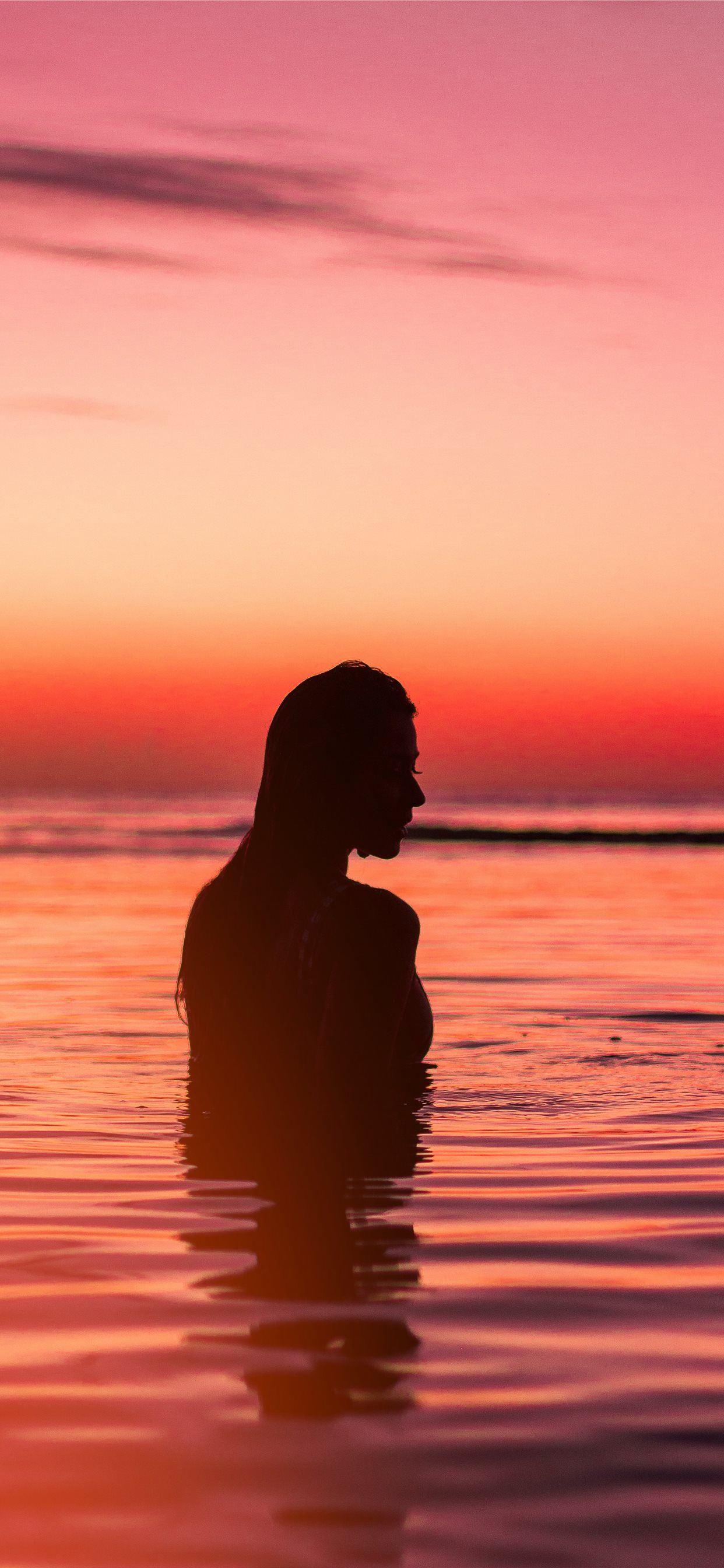 1242x2688 silhouette of woman in body of water iPhone X Wallpaper Free Download