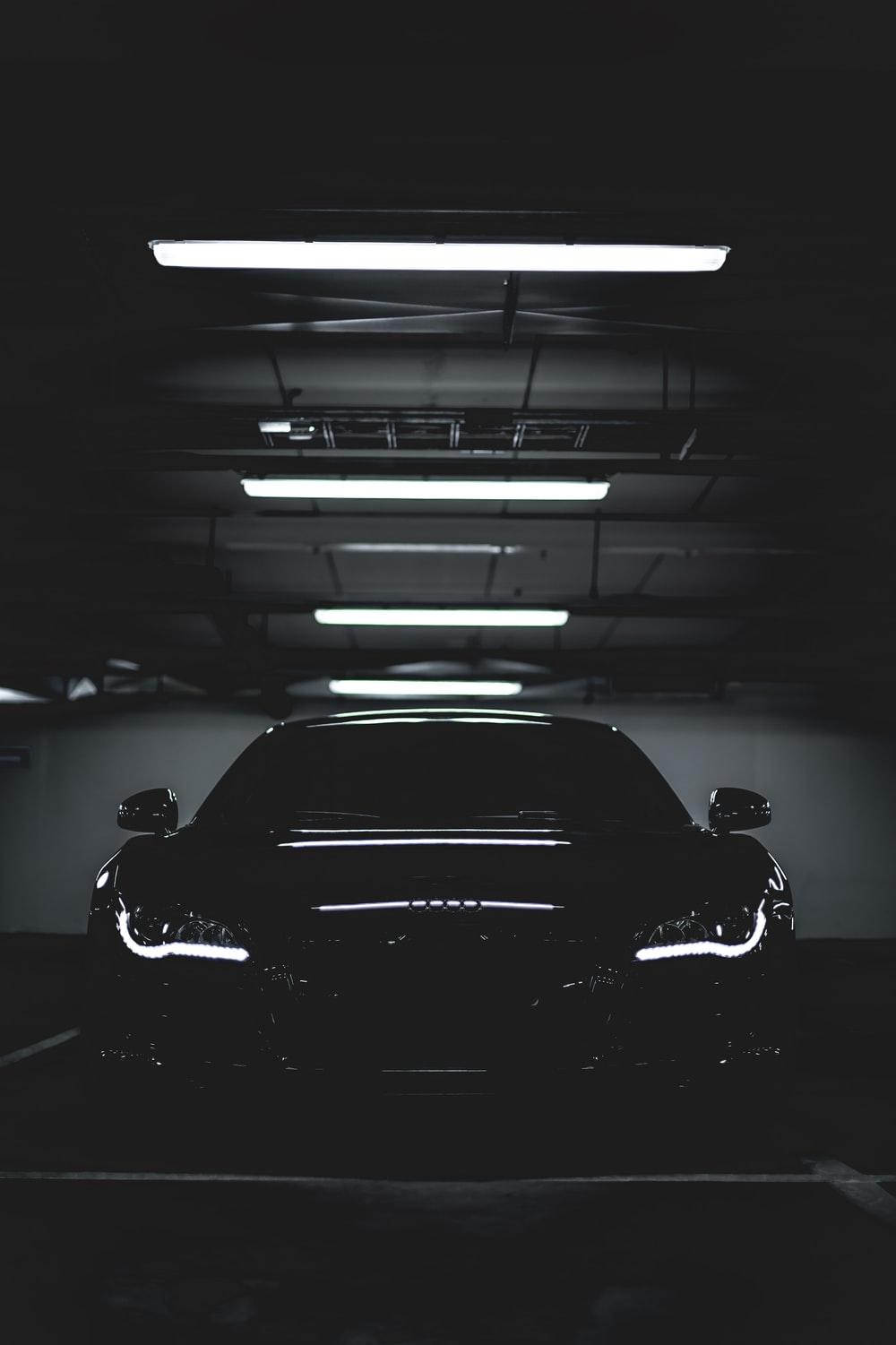 Grayscale Photo of a Sports Car Parked on the Road  Free Stock Photo
