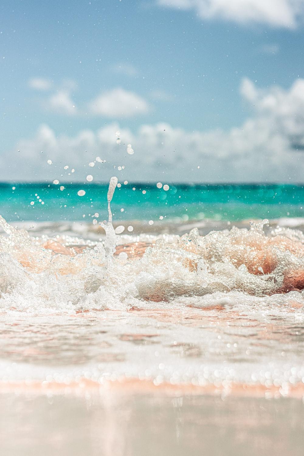 1000x1500 water waves on shore during daytime photo