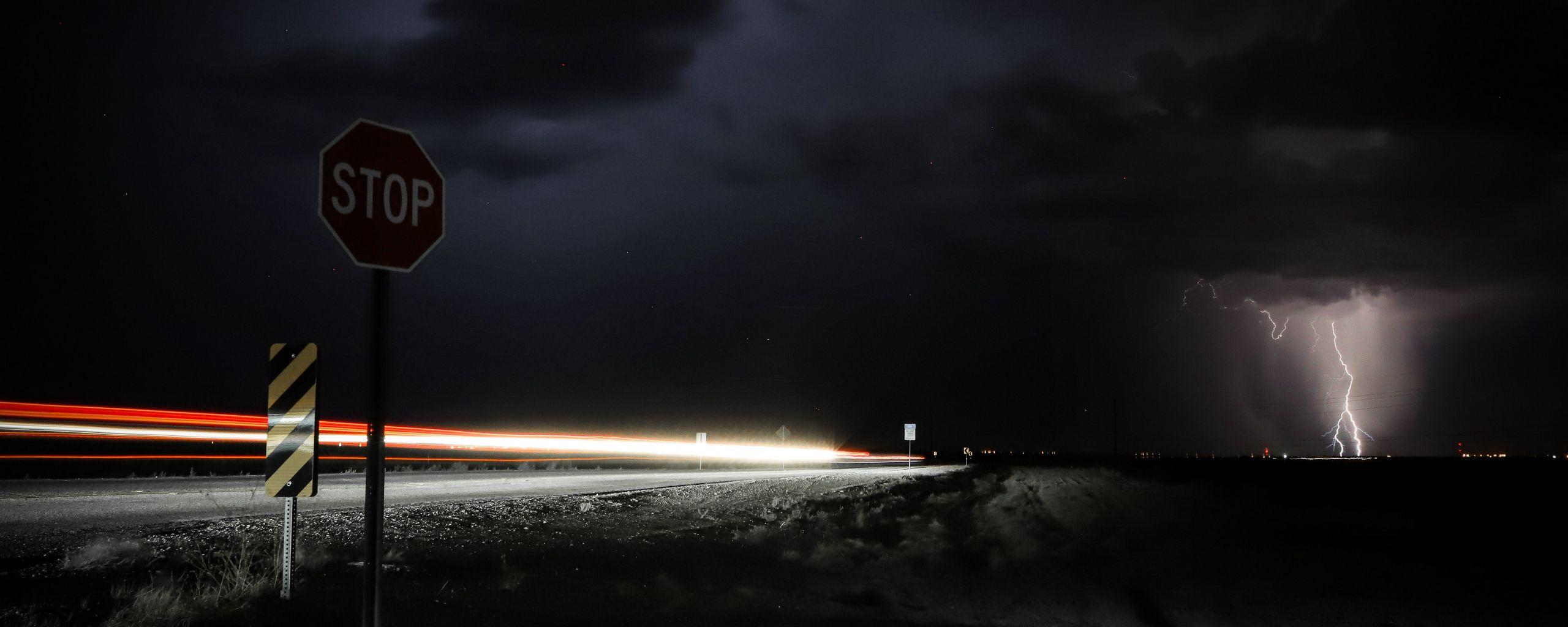 2560x1024 Download wallpaper 2560x1024 signs, road, night, dark, thunderstorm ultrawide monitor HD background