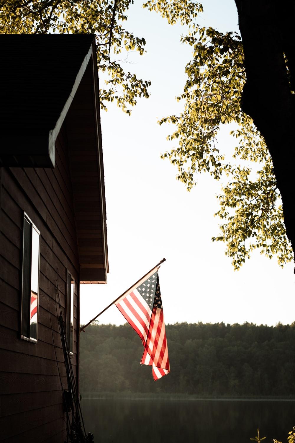 1000x1500 us a flag on white wooden house photo